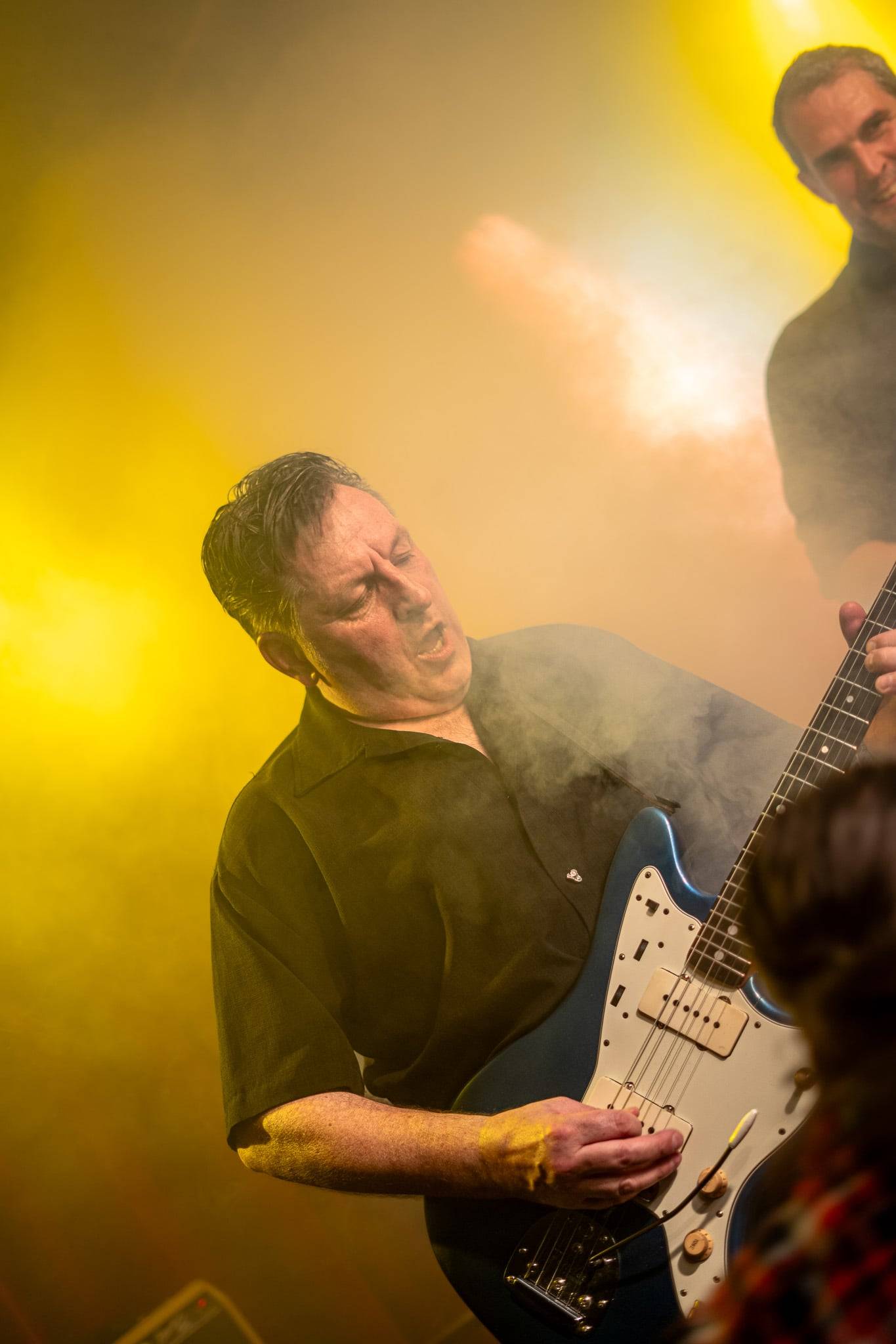 Gitarzysta w żółtym świetle scenicznym