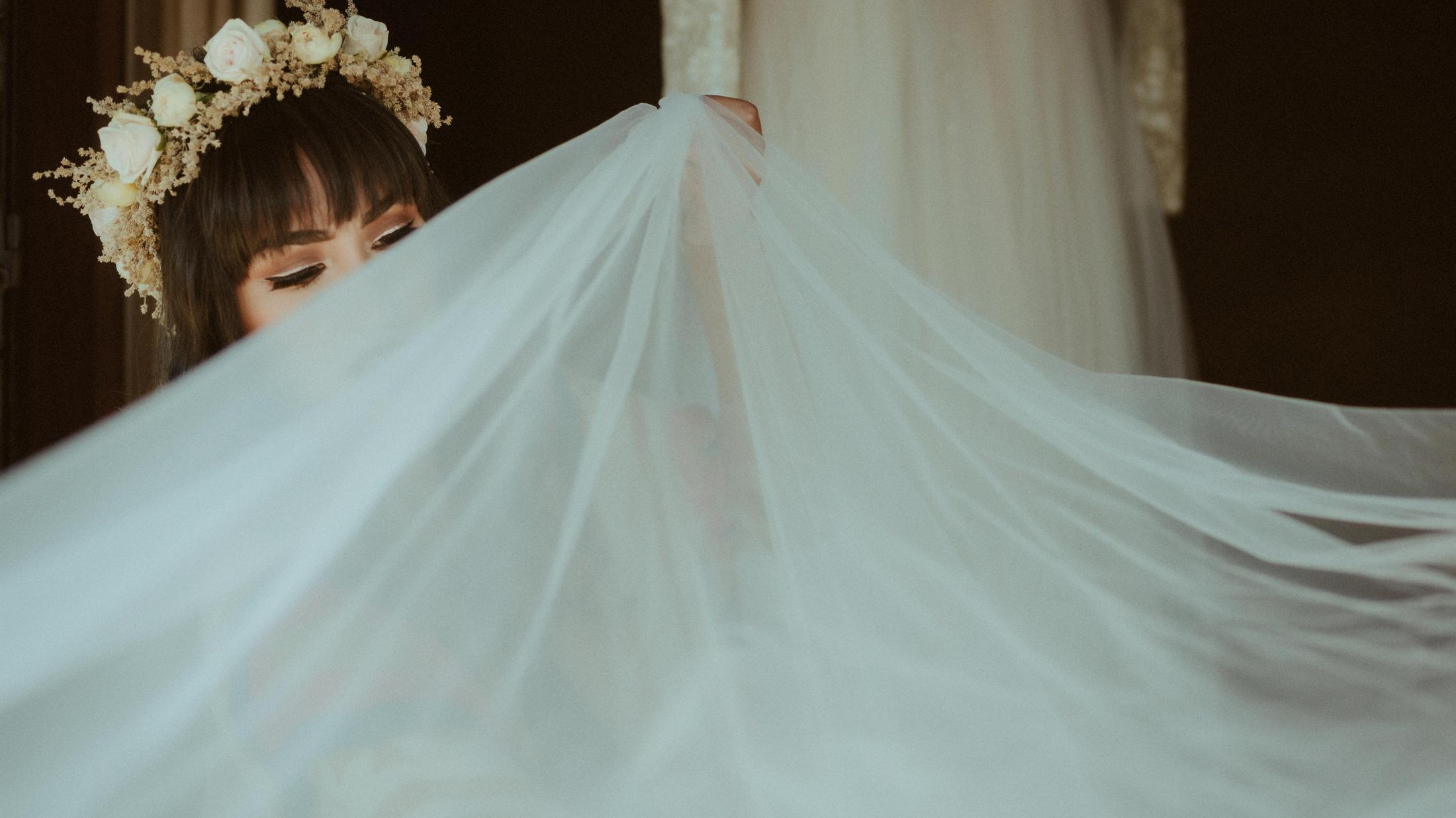 Anna wird von ihrem Hochzeitsschleier gerahmt.