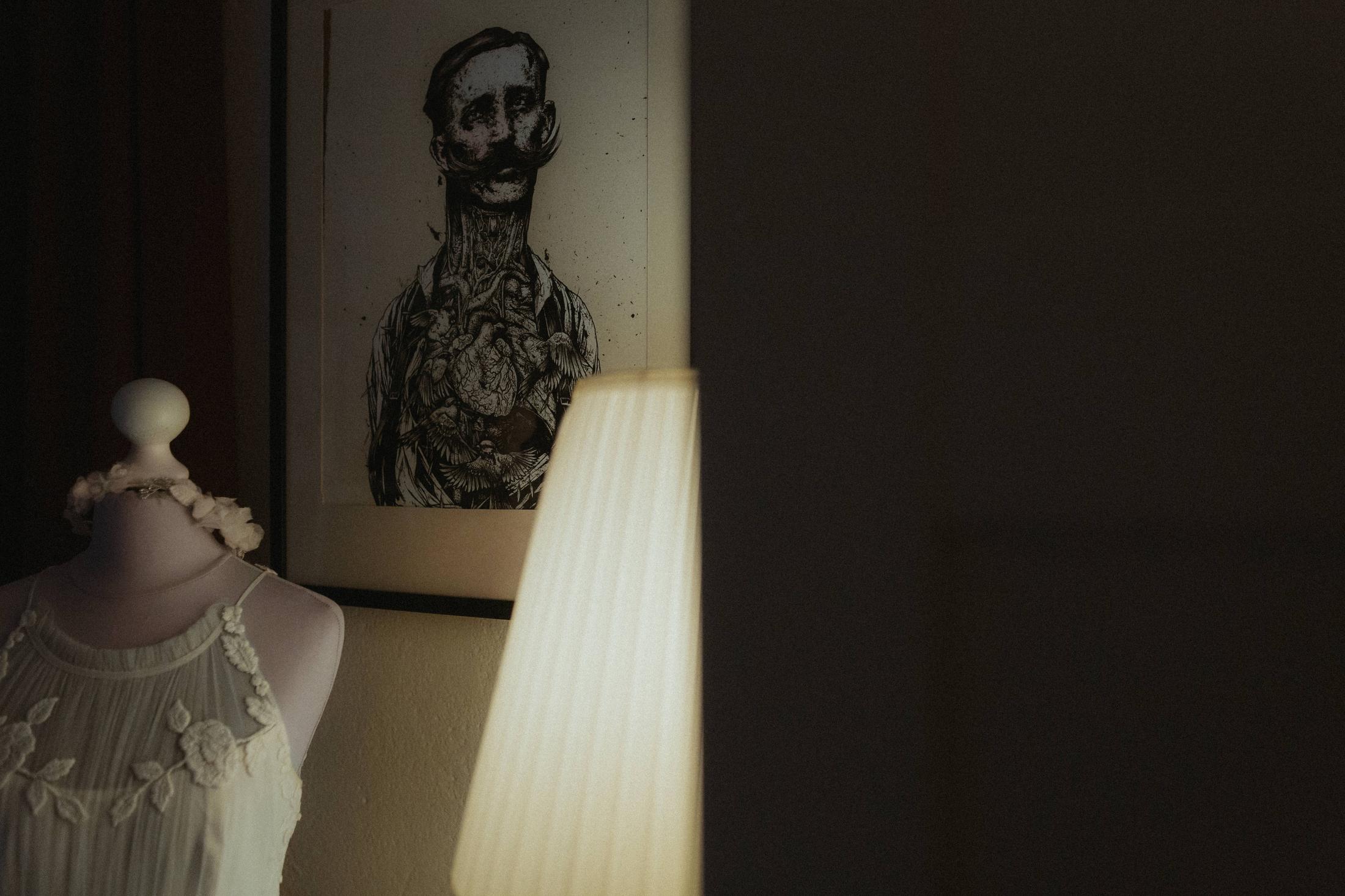 A lamp and framed drawing in a quiet corner of Anki’s apartment.