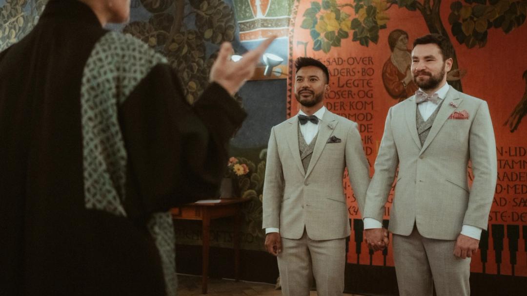 Kris and Ilya stand before the registrar during their Copenhagen City Hall ceremony.