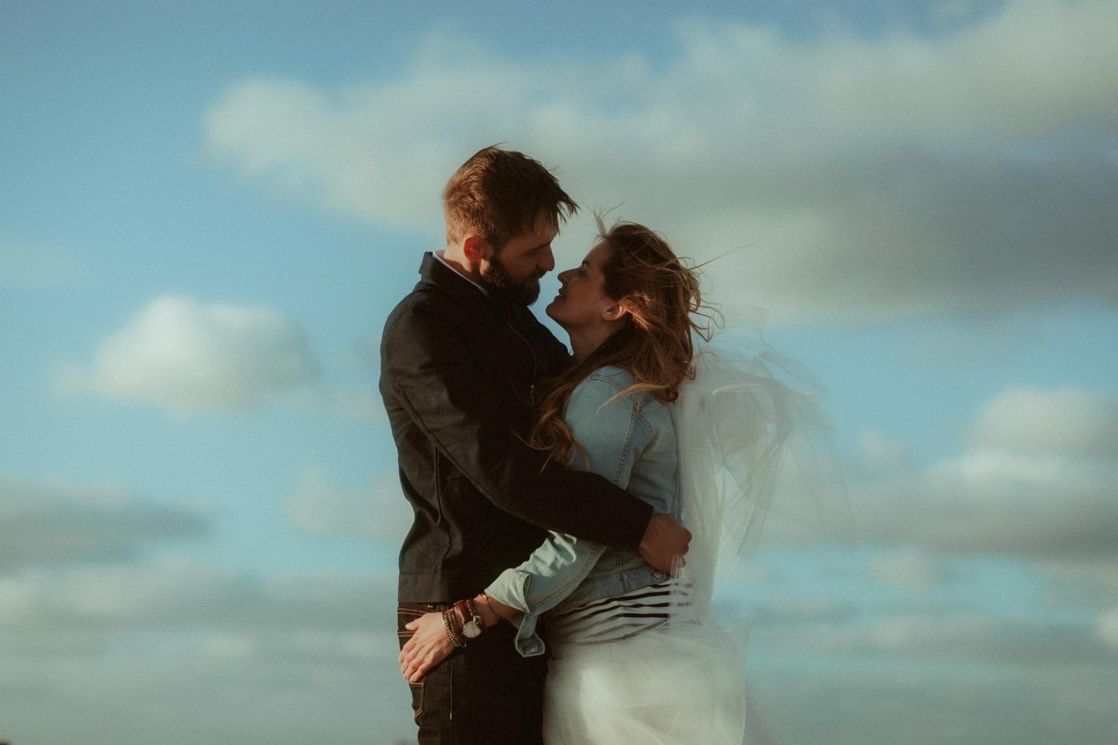 Mary and Robo hold each other closely on the coast at St. Peter-Ording.