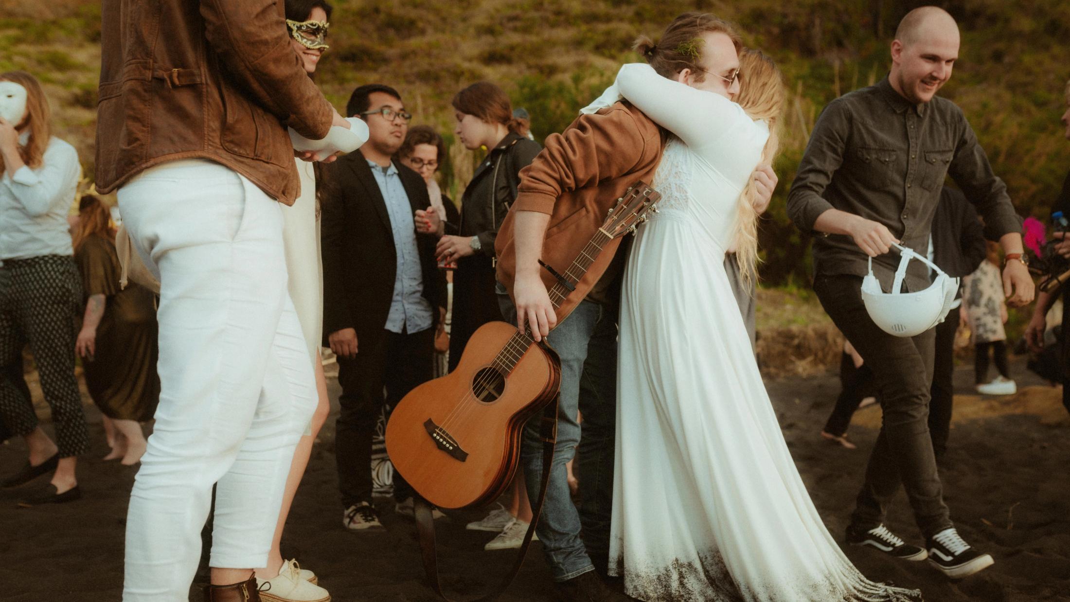 Twyla embraces the musician after the beach wedding.