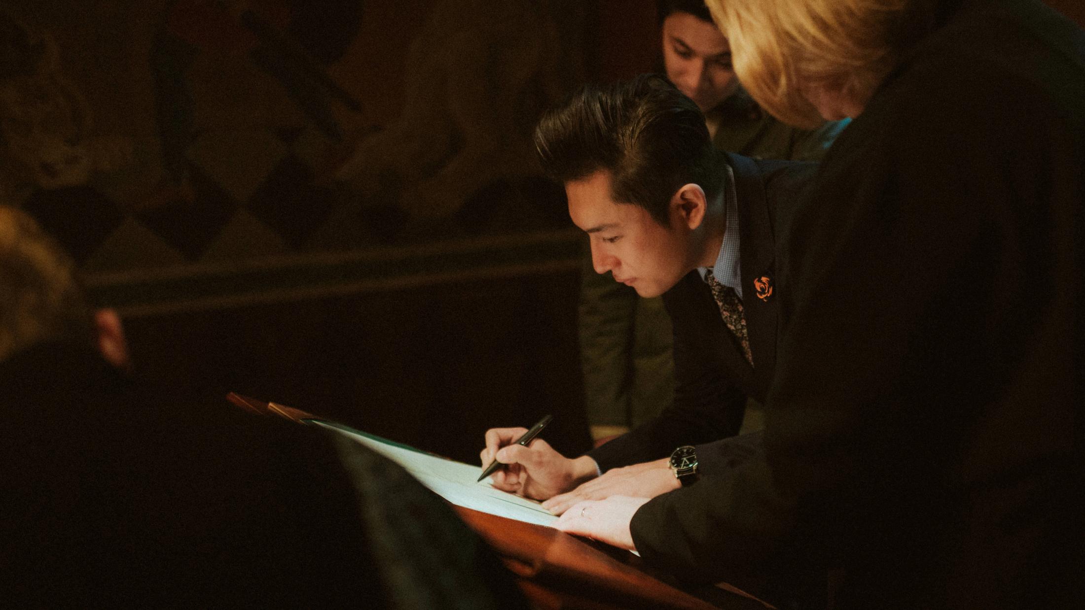 Kevin and Terence sign the marriage register together.