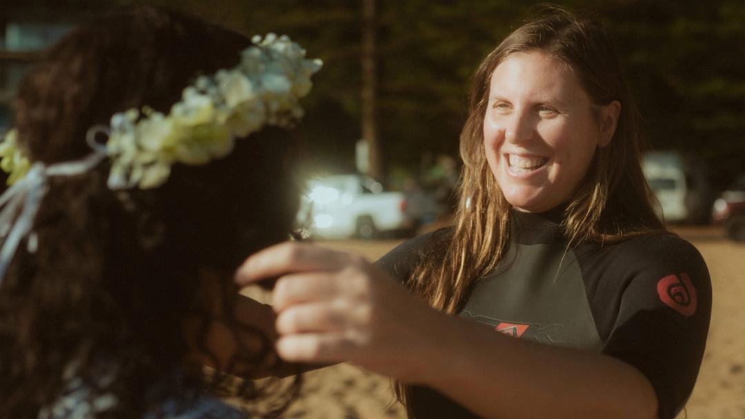 The celebrant smiling while holding flowers near Petra