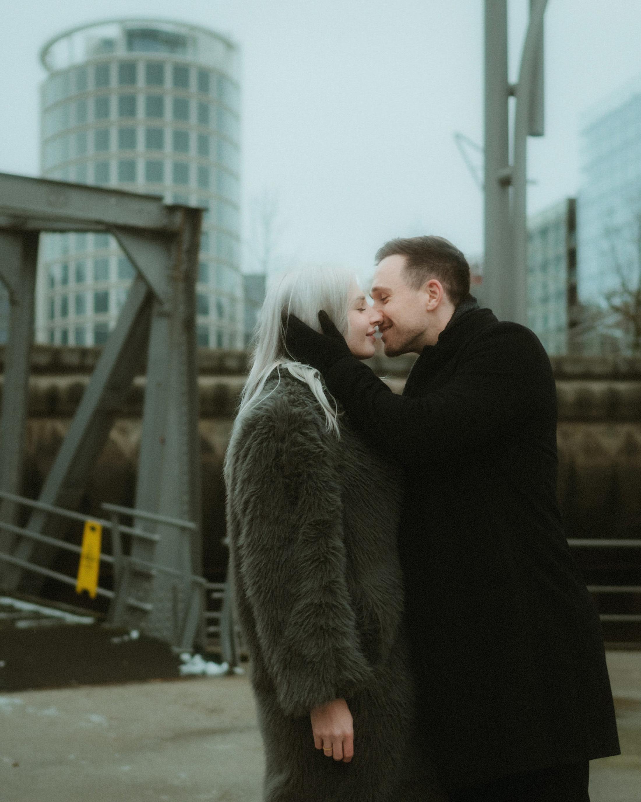 Lorelai and Steffen kiss beside the harbour on a cold winter afternoon.