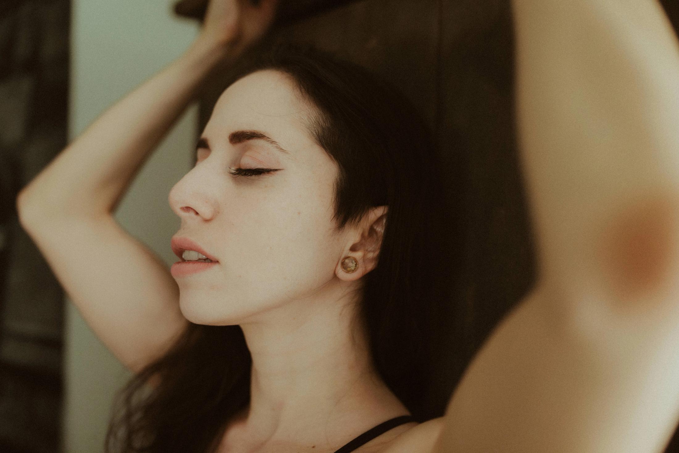 Close portrait of Maya with one hand resting behind her head.