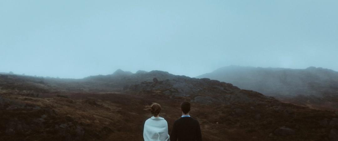 Jule and Rory standing on rocks above the coast of the Cooley Peninsula