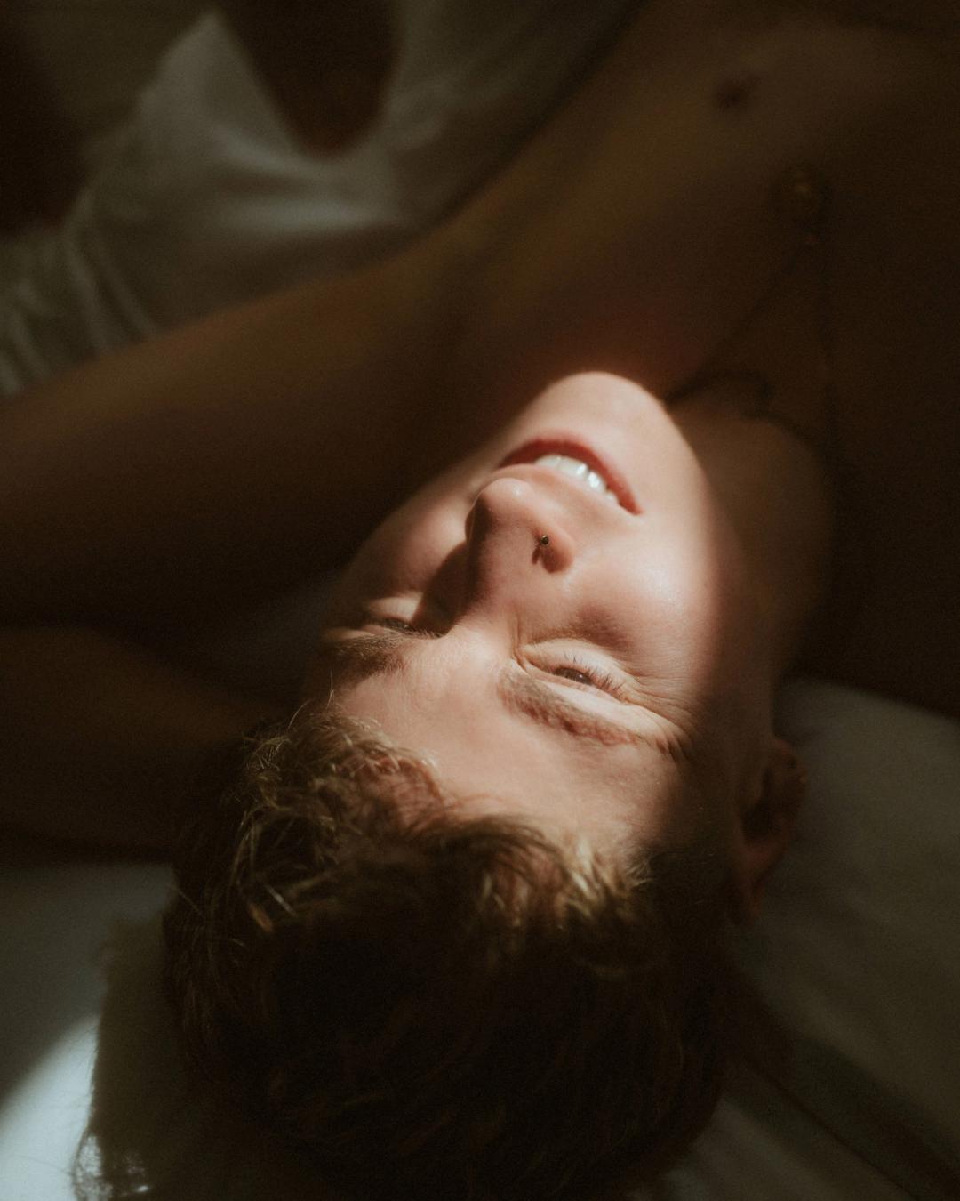 Close portrait of Noah looking toward Michèle in soft window light.