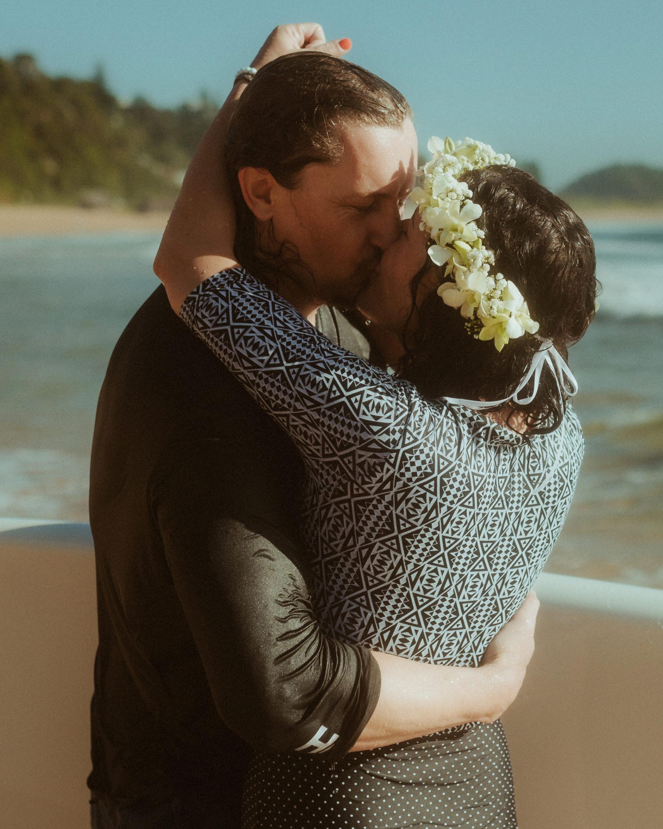 Petra and Roman embracing on the beach after the ceremony