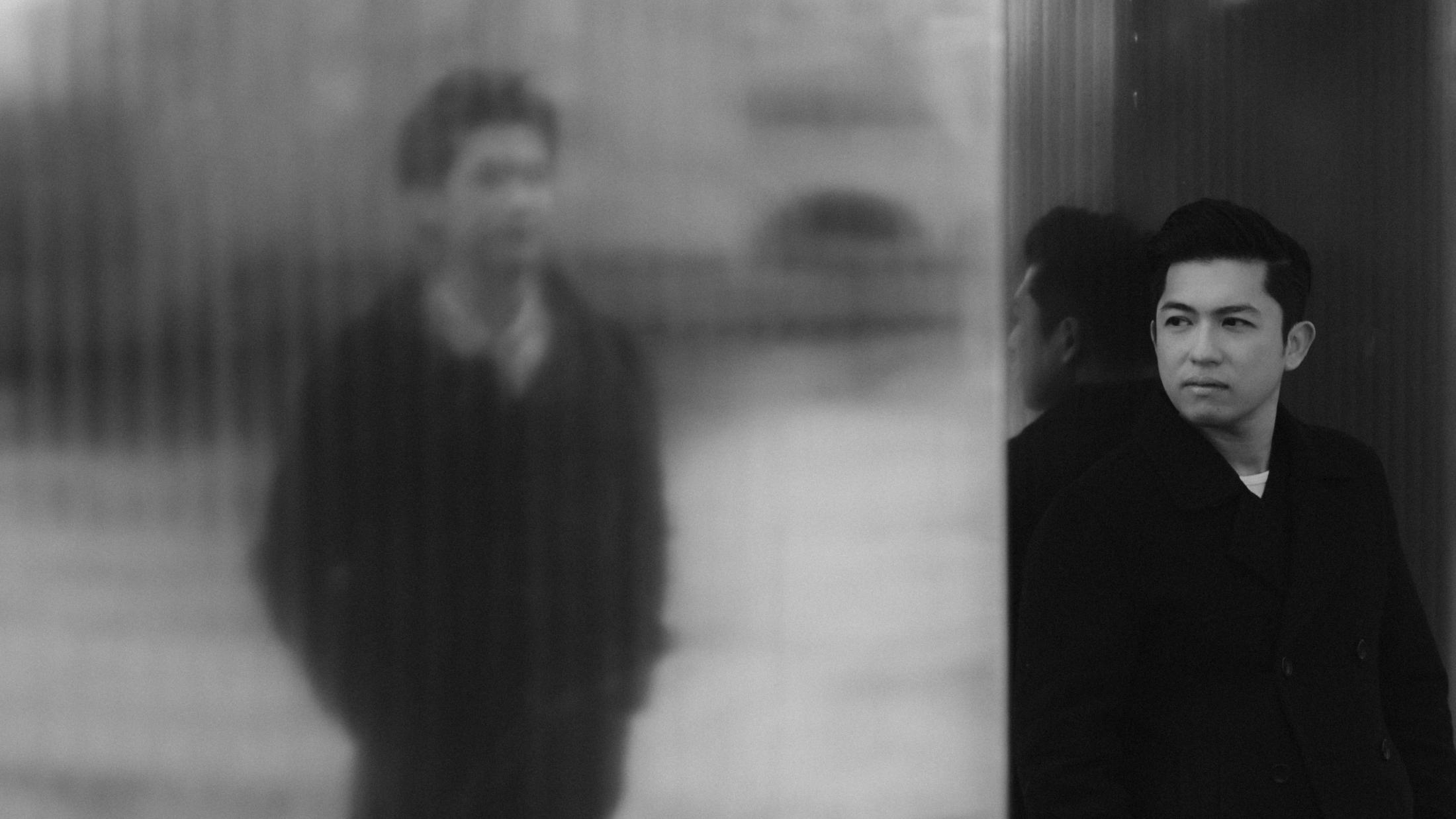 One of the men appears sharply beside the blurred silhouette of his partner.
