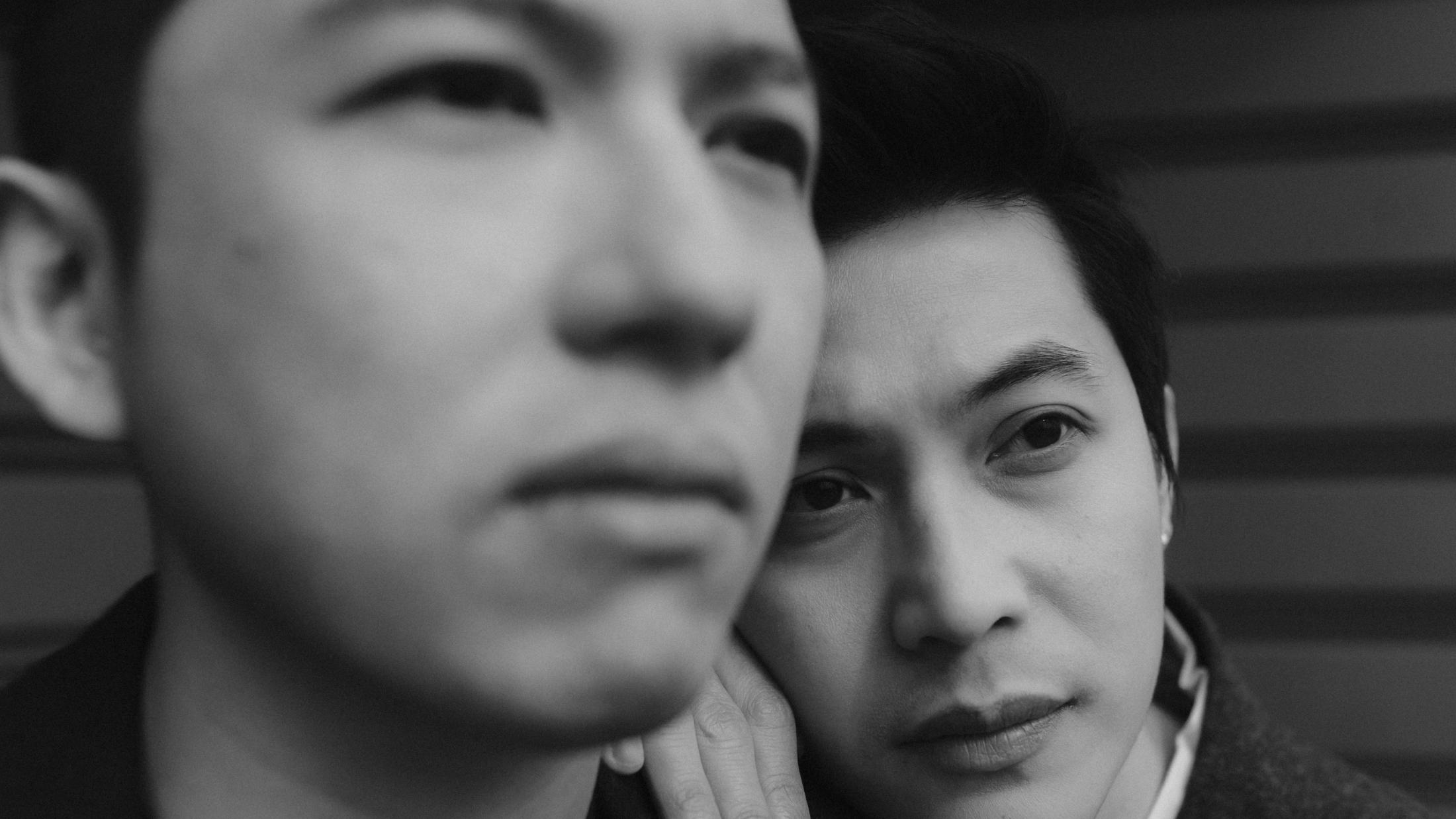 Kevin and Terence appear close together in a soft, blurred black-and-white portrait.