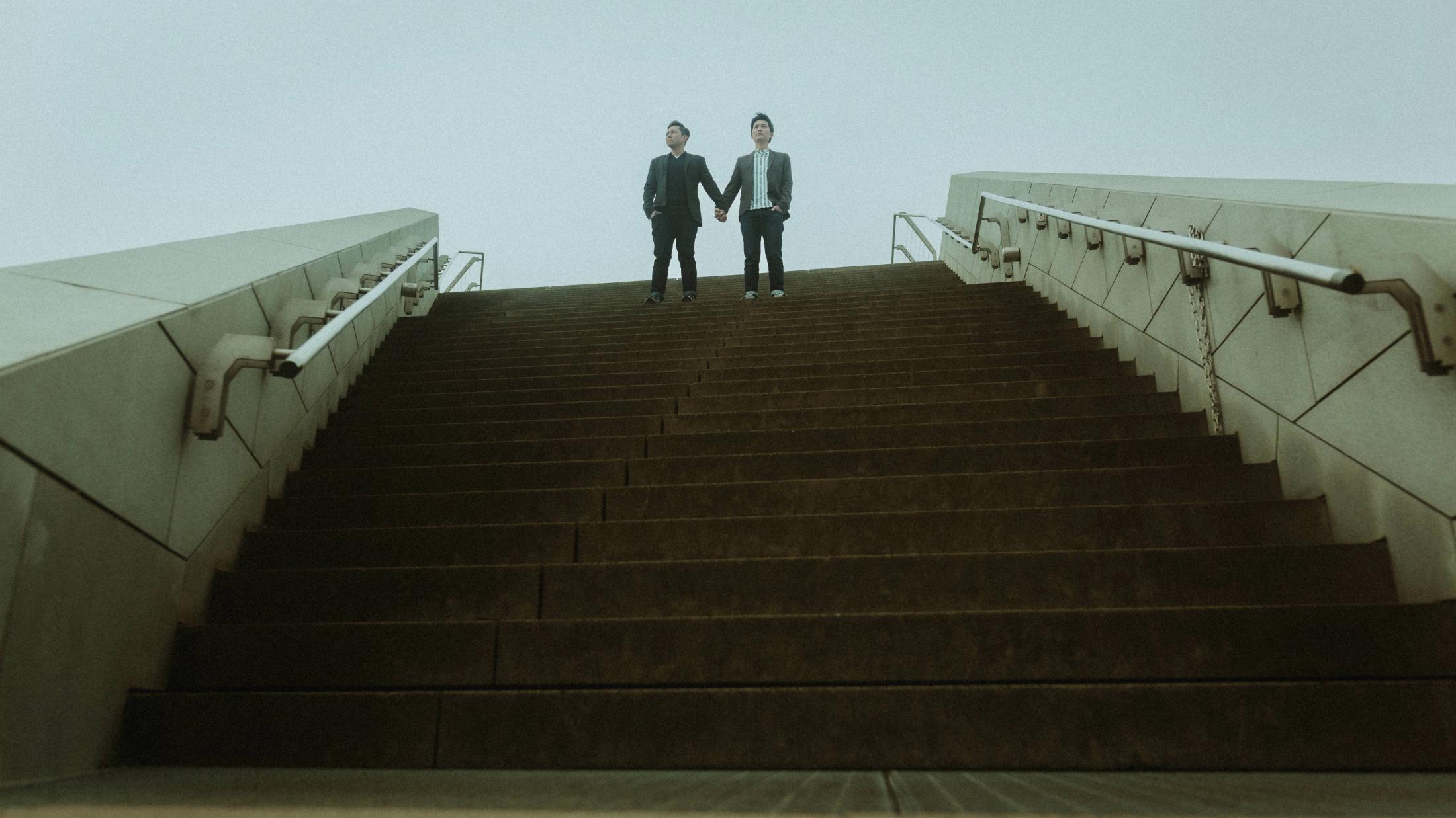 Kevin and Terence stand at the top of a broad outdoor staircase.