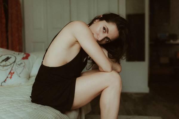 Dancer Maya extending one leg across a wooden barre in her Manhattan apartment.