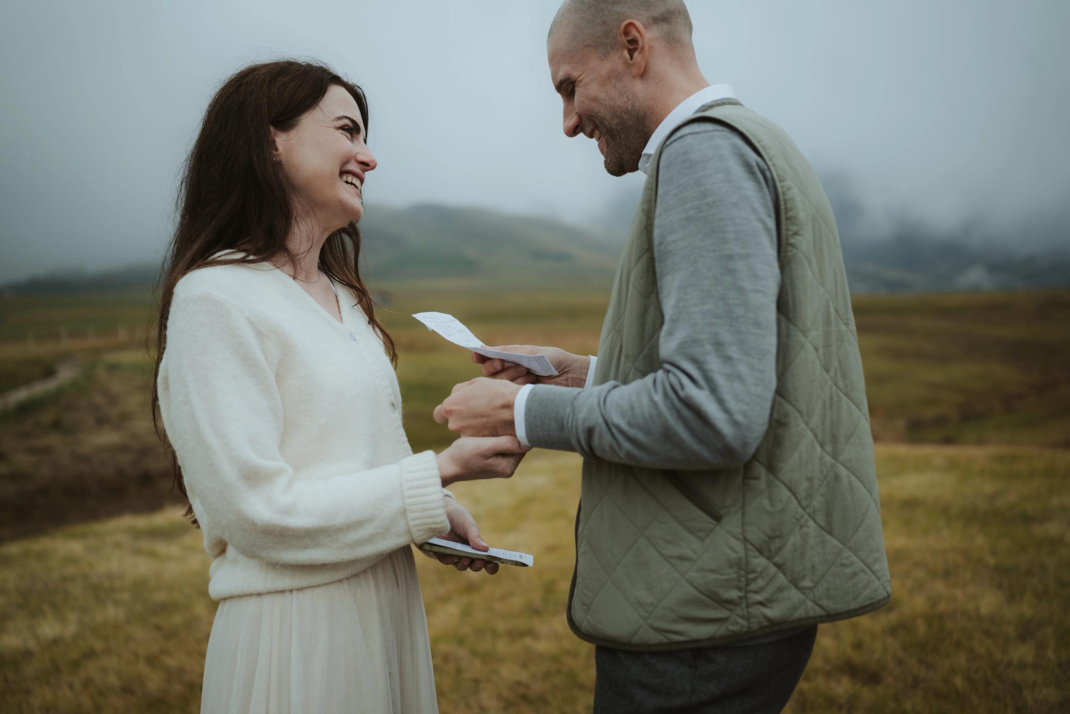Steffen reading handwritten vows to Jana outdoors.