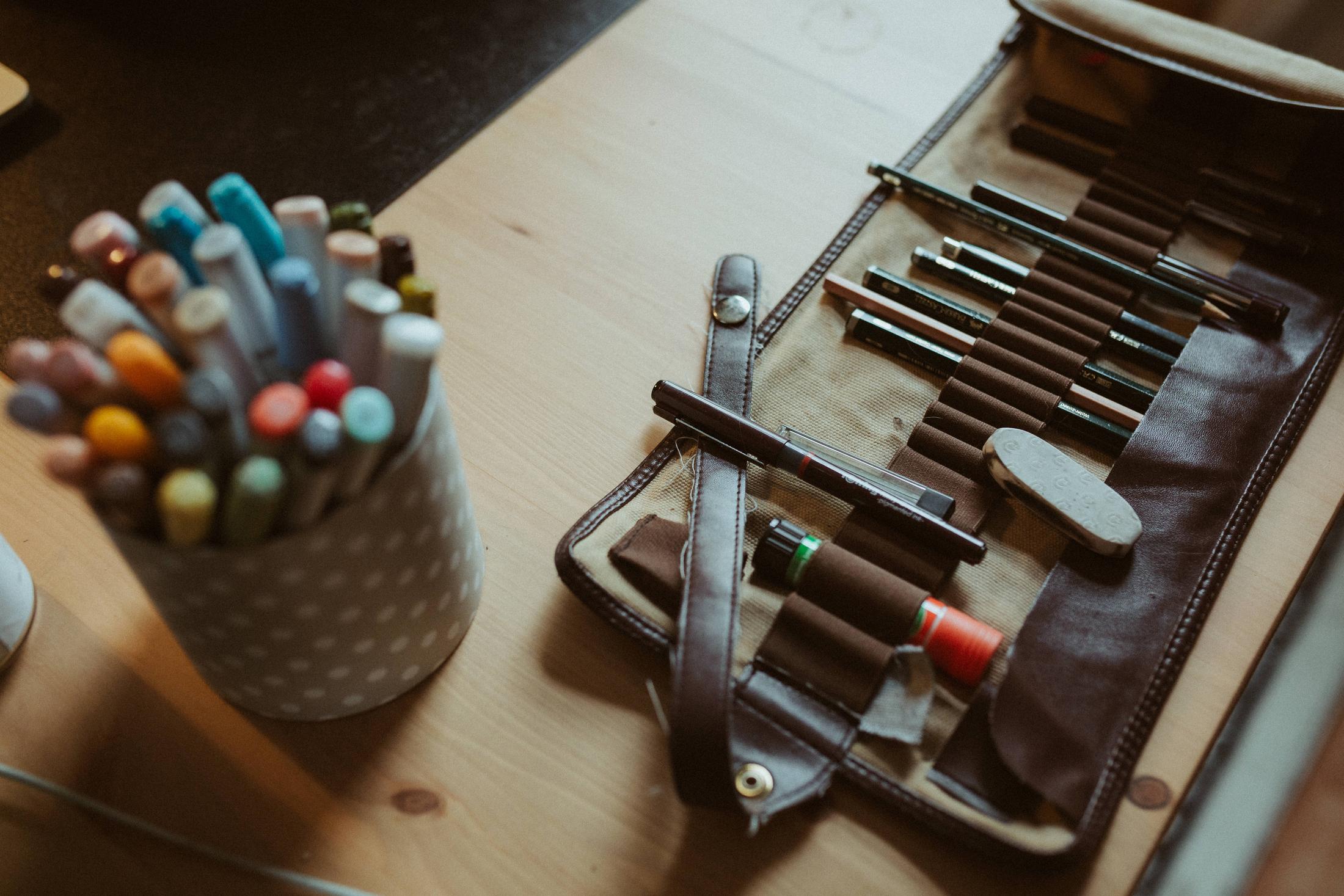 Pens, brushes and drawing tools arranged on Anki’s desk.