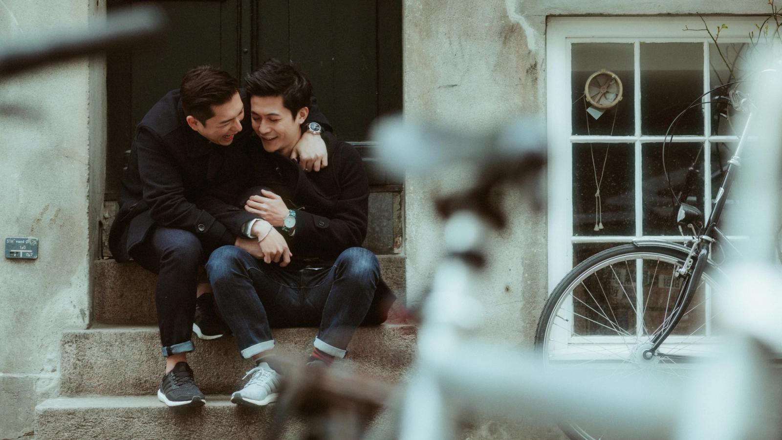 Kevin and Terence laughing together on a doorstep in Copenhagen