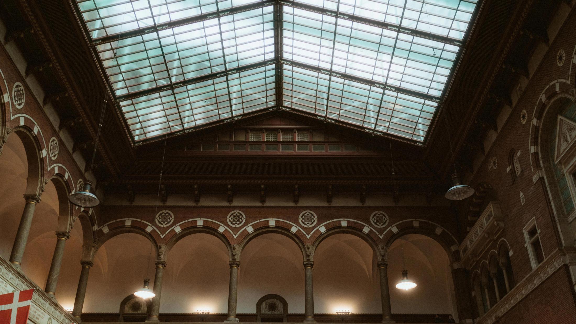 Glass roof and brick architecture inside Copenhagen City Hall