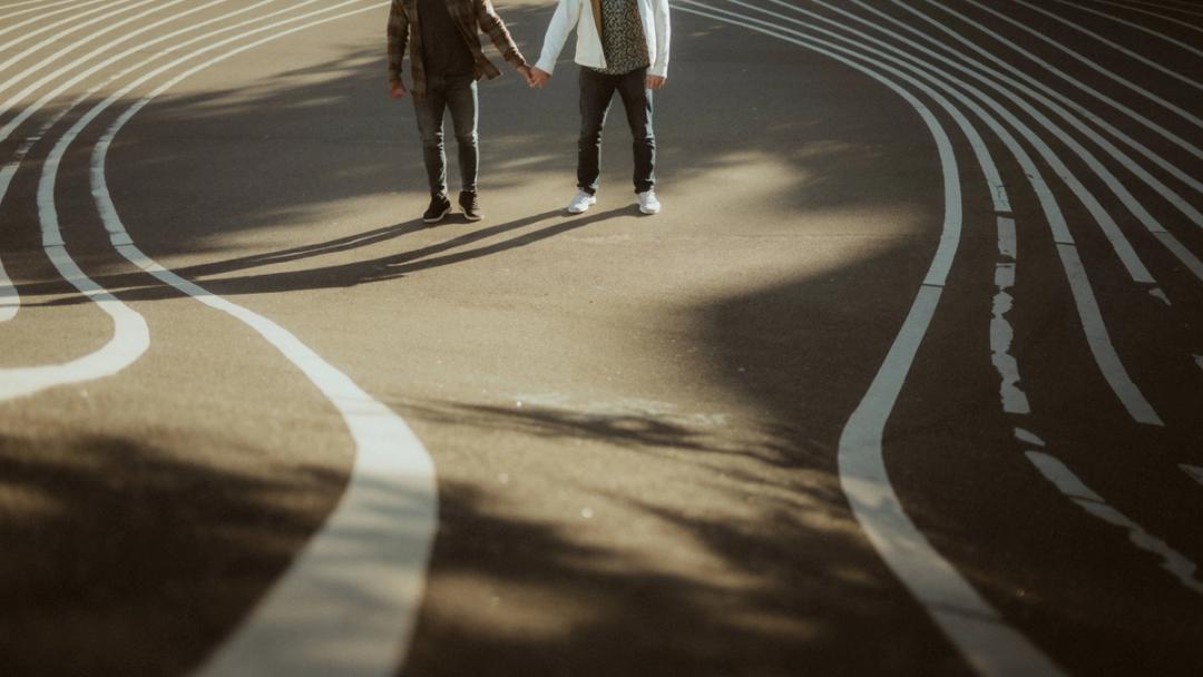 Couple photographed among the graphic lines of Superkilen in Nørrebro, Copenhagen