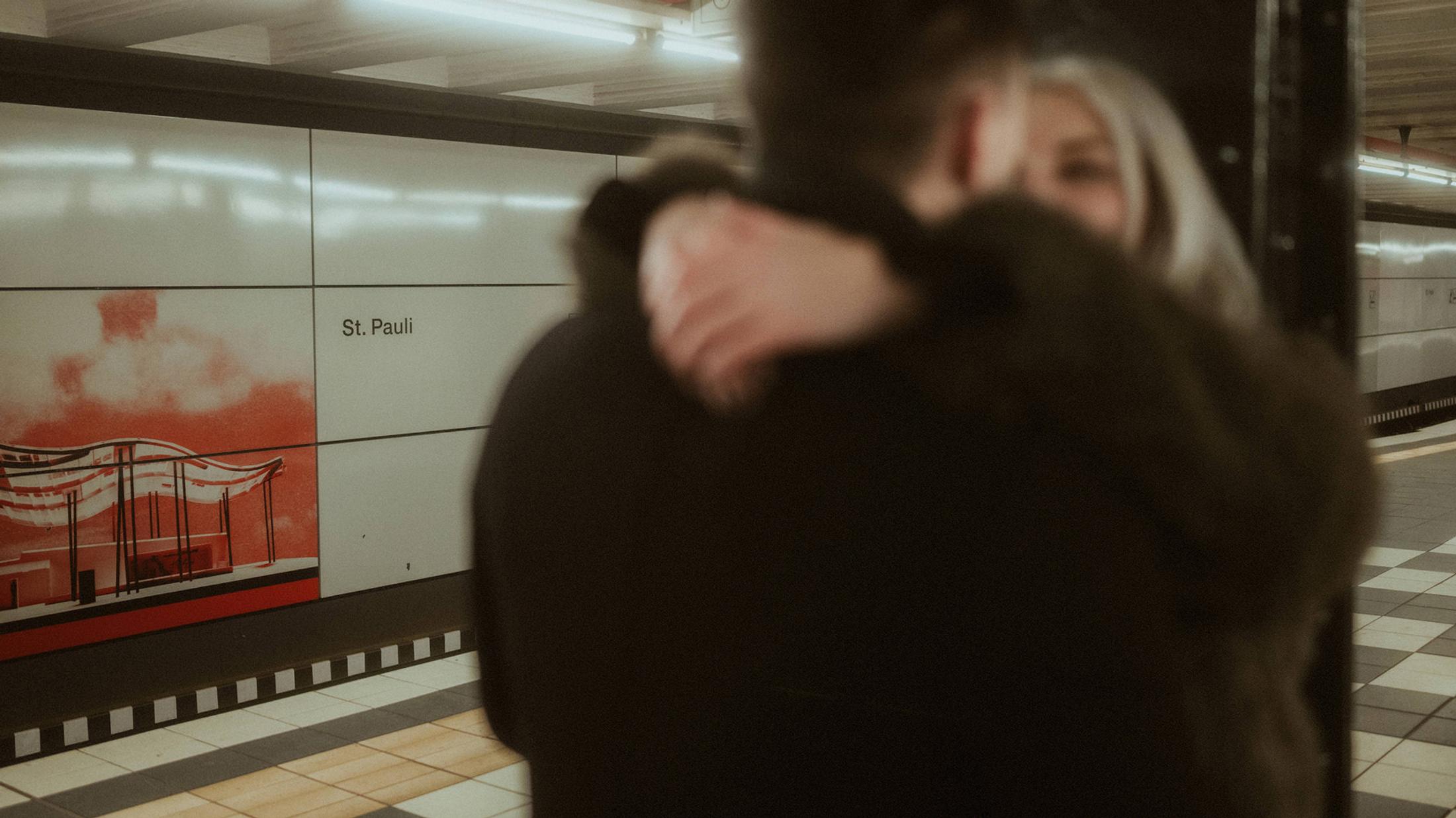 Lorelai wraps her arms around Steffen on the station platform.