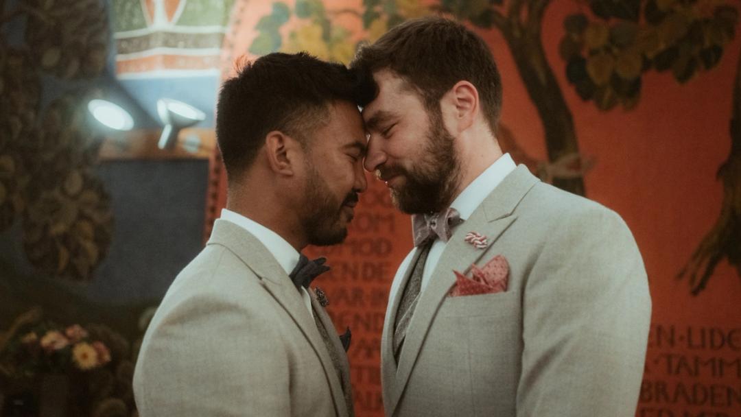 Kris and Ilya close their eyes and touch foreheads after the ceremony.