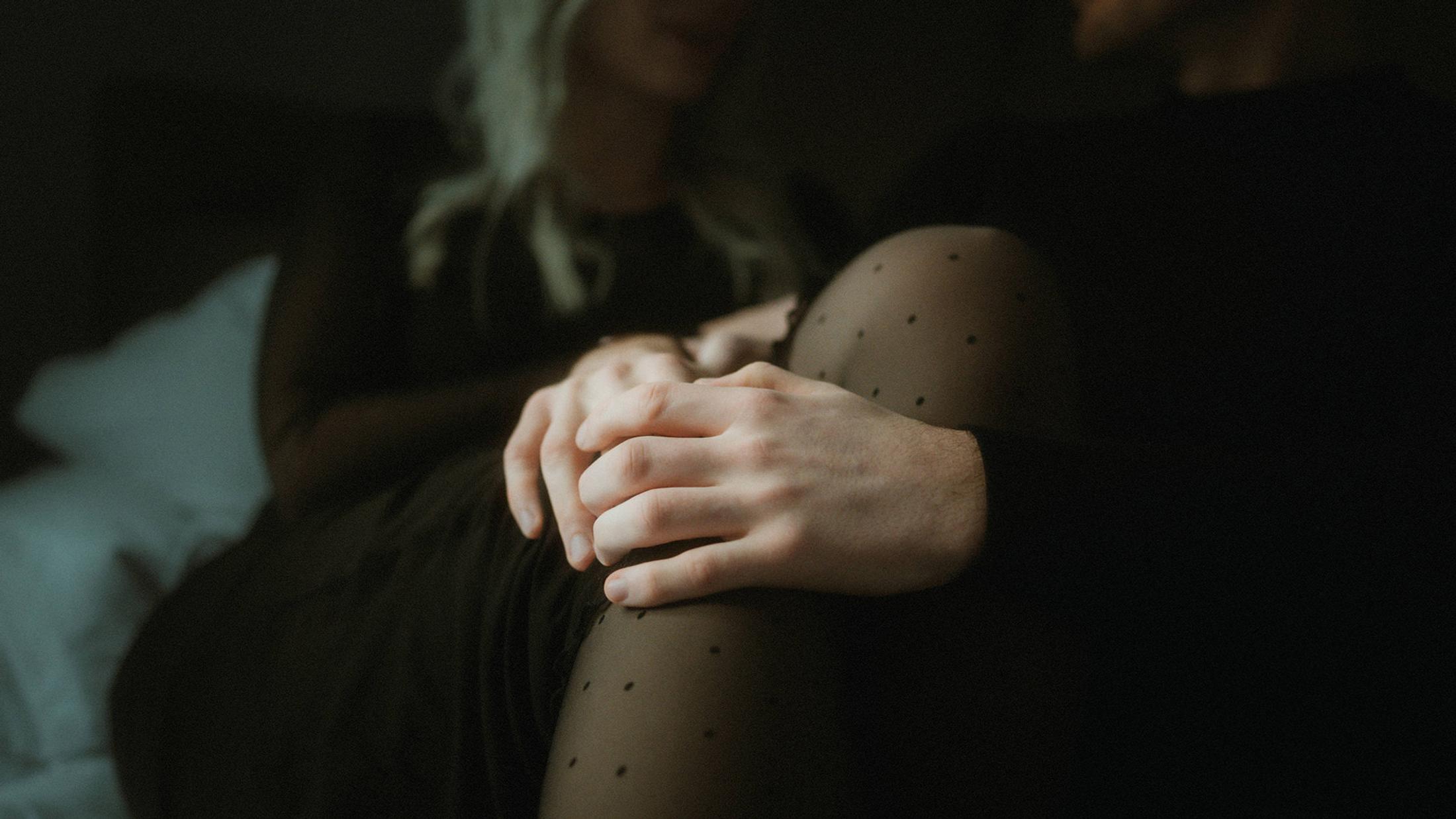 Steffen's hands rest over Lorelai's hands and dotted tights.