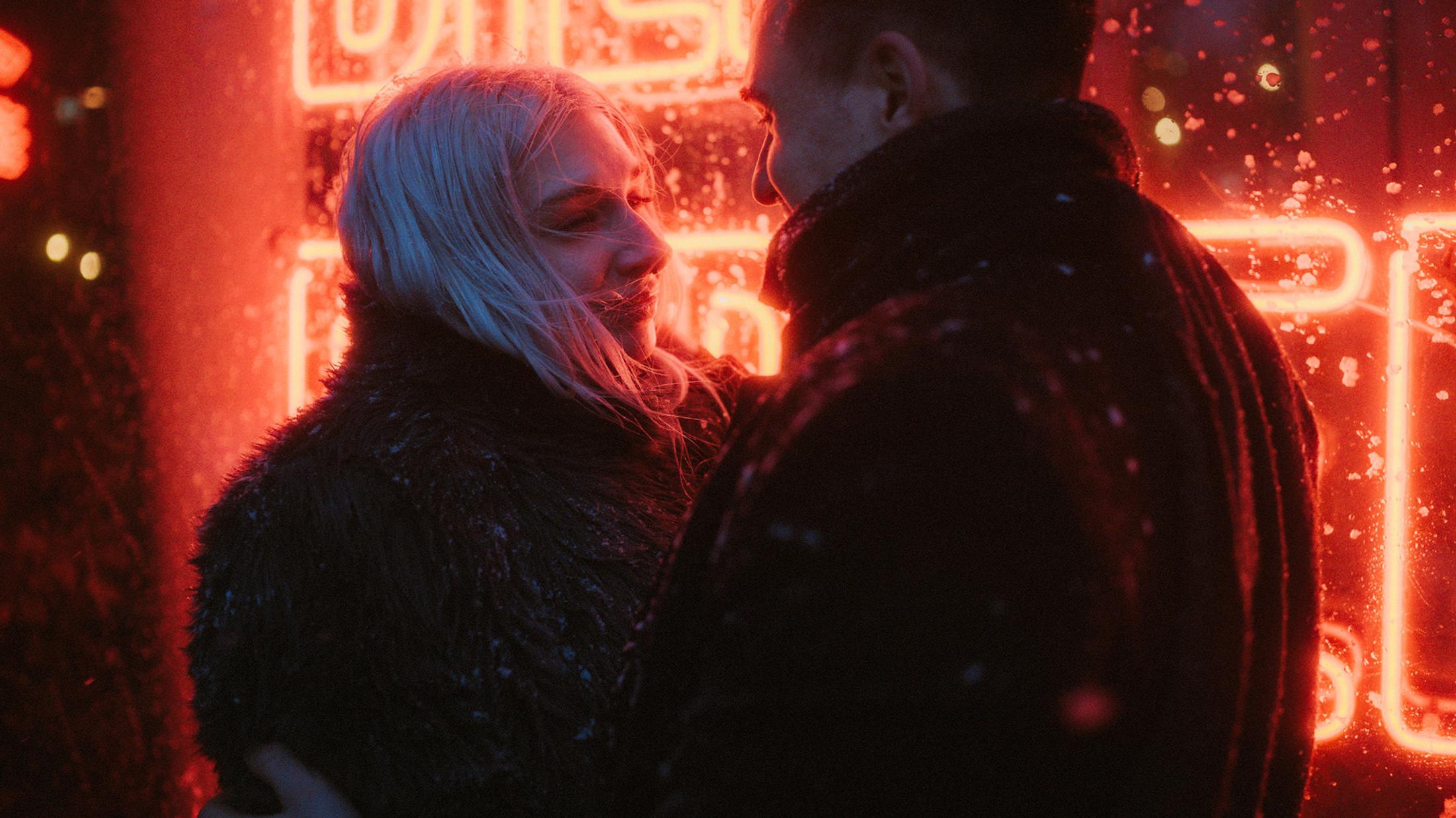 Lorelai and Steffen embrace in front of the neon window during the snowstorm.