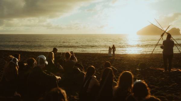 Twyla and Gary stand among their surprised wedding guests on the coast of São Miguel.