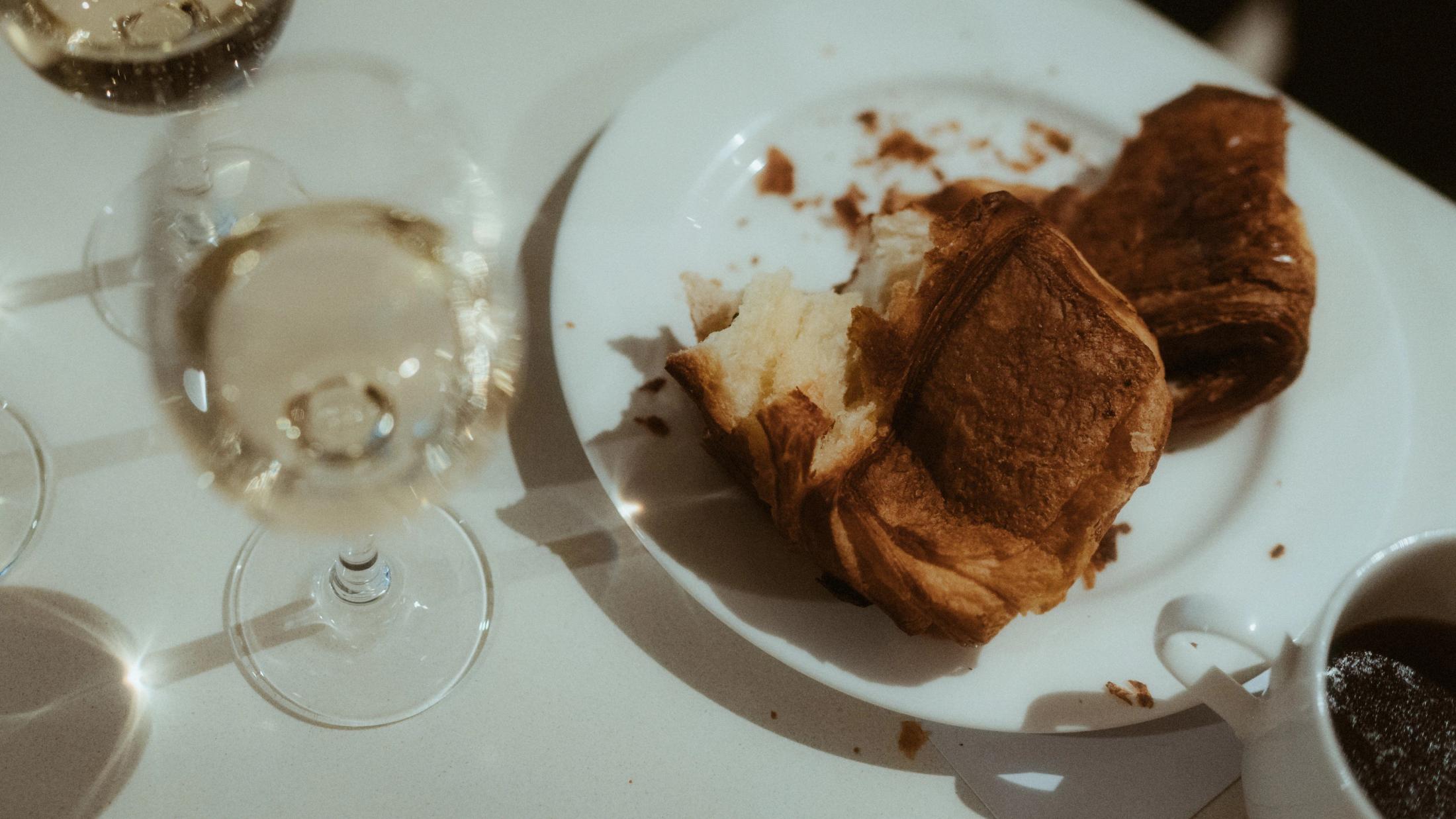 Pastry, plates and glasses on the breakfast table