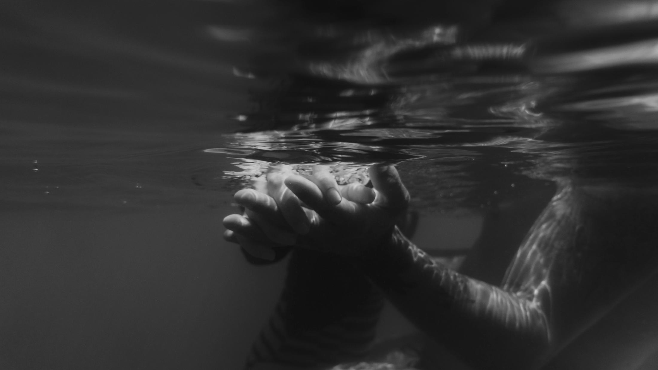 Angela and Ivan floating together beneath the water