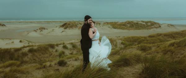 Windswept close portrait of Anni and Daniel with their faces side by side.