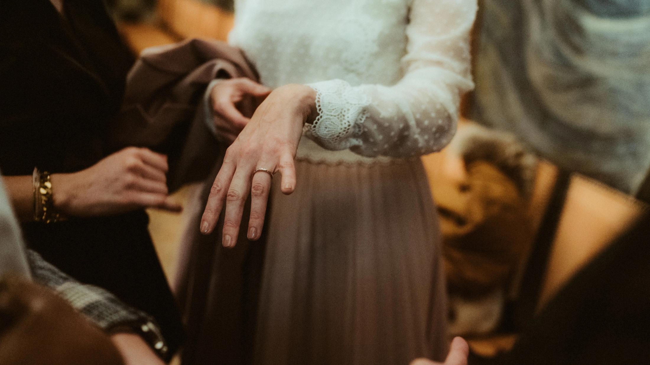 Ari and Pia's ringed hands resting together