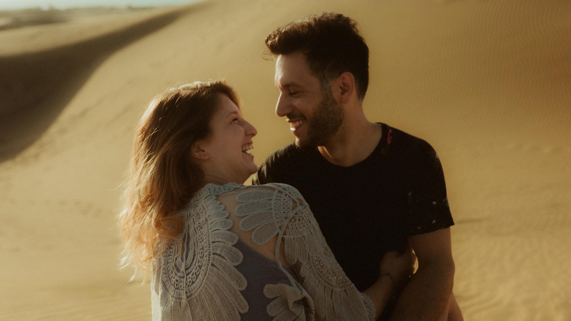 Katja and David laughing together in warm light.