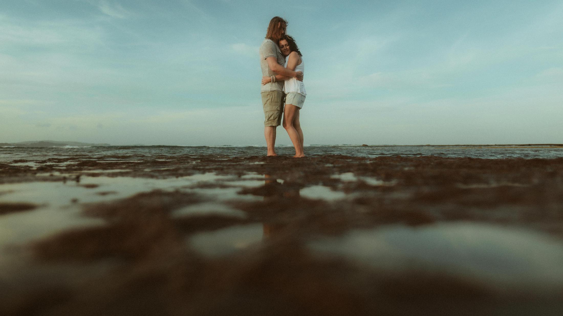 Petra and Roman standing together in shallow water, seen from a low angle