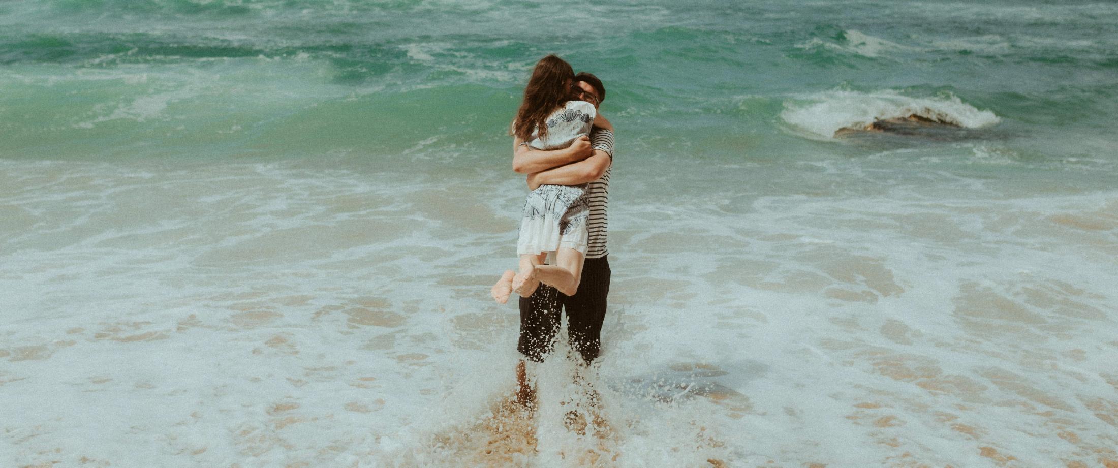 Surf embrace during Ana and Till's Lovers Session in Portugal.