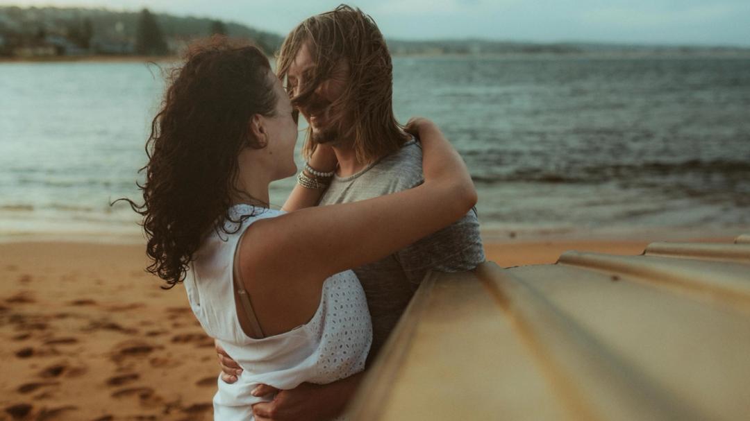 Petra holding Roman around the shoulders near the water