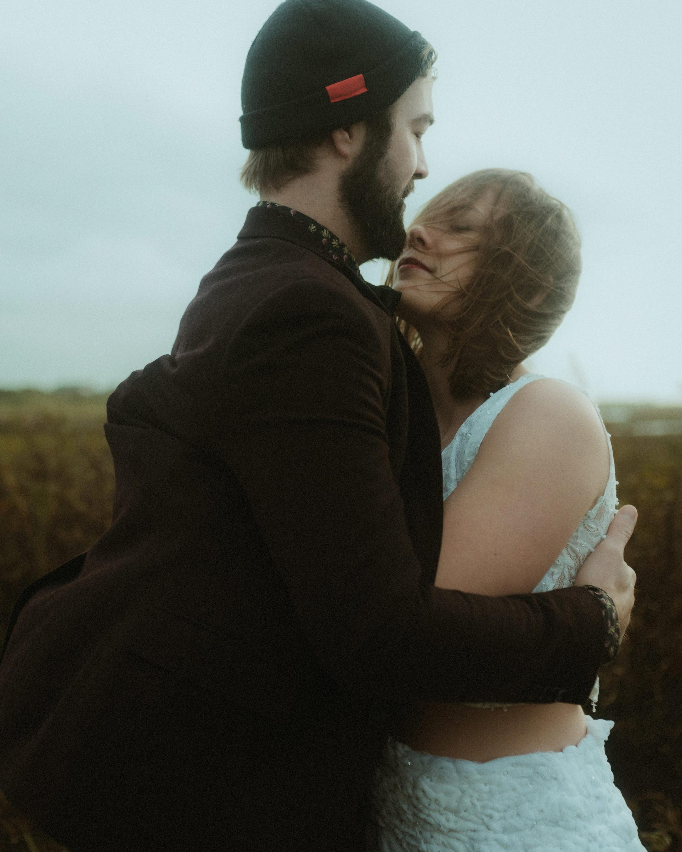 Anni and Daniel turn into a moving embrace beneath the overcast sky.