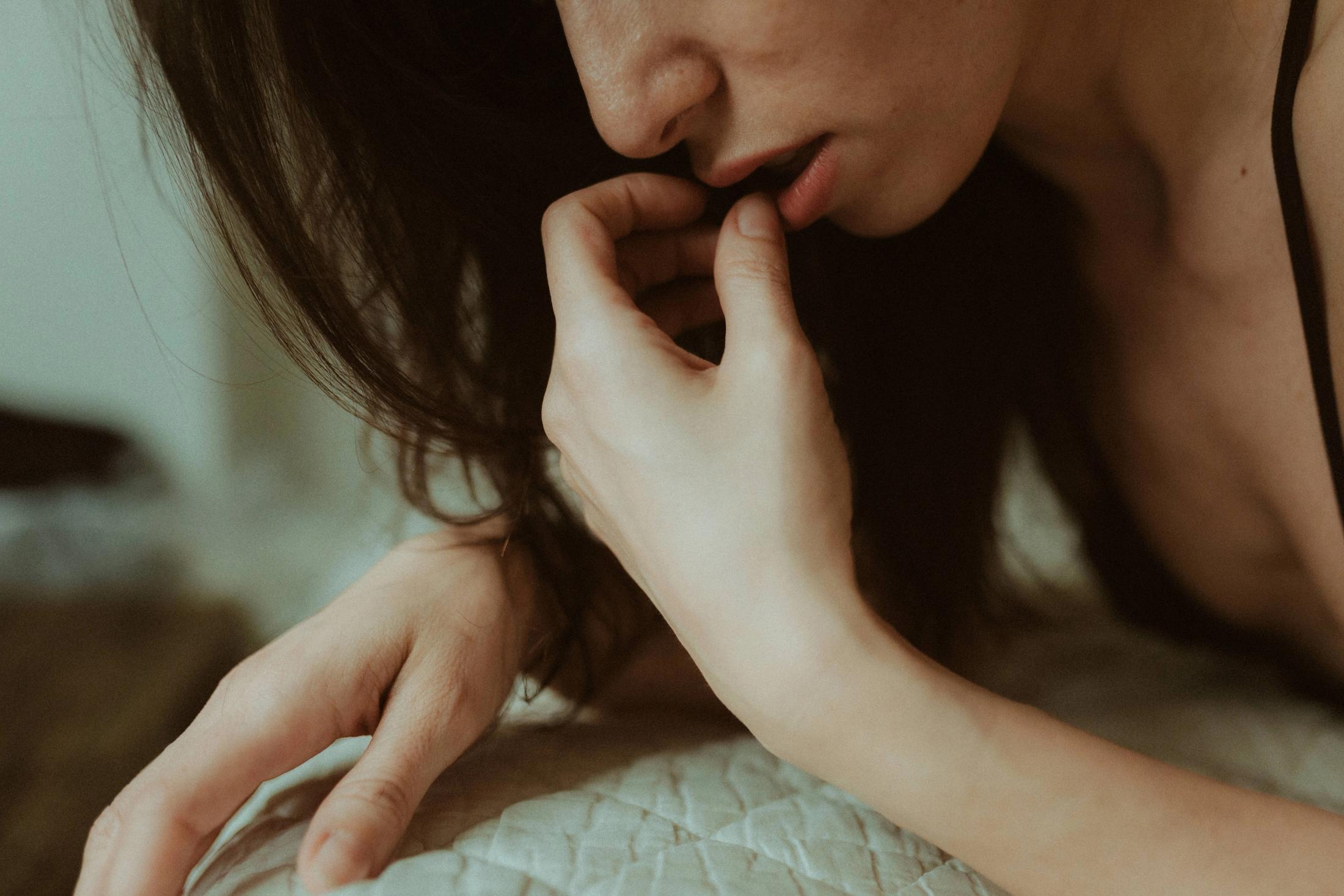 Intimate detail of Maya’s hands framing her face.
