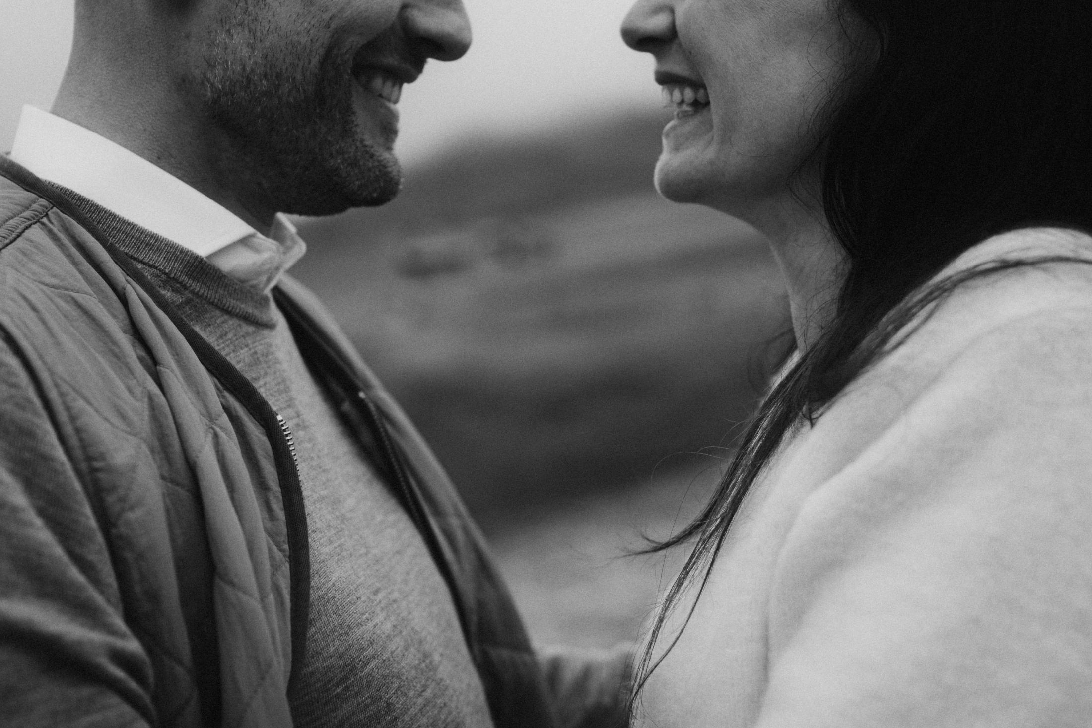 Close black-and-white portrait of Jana and Steffen smiling together.