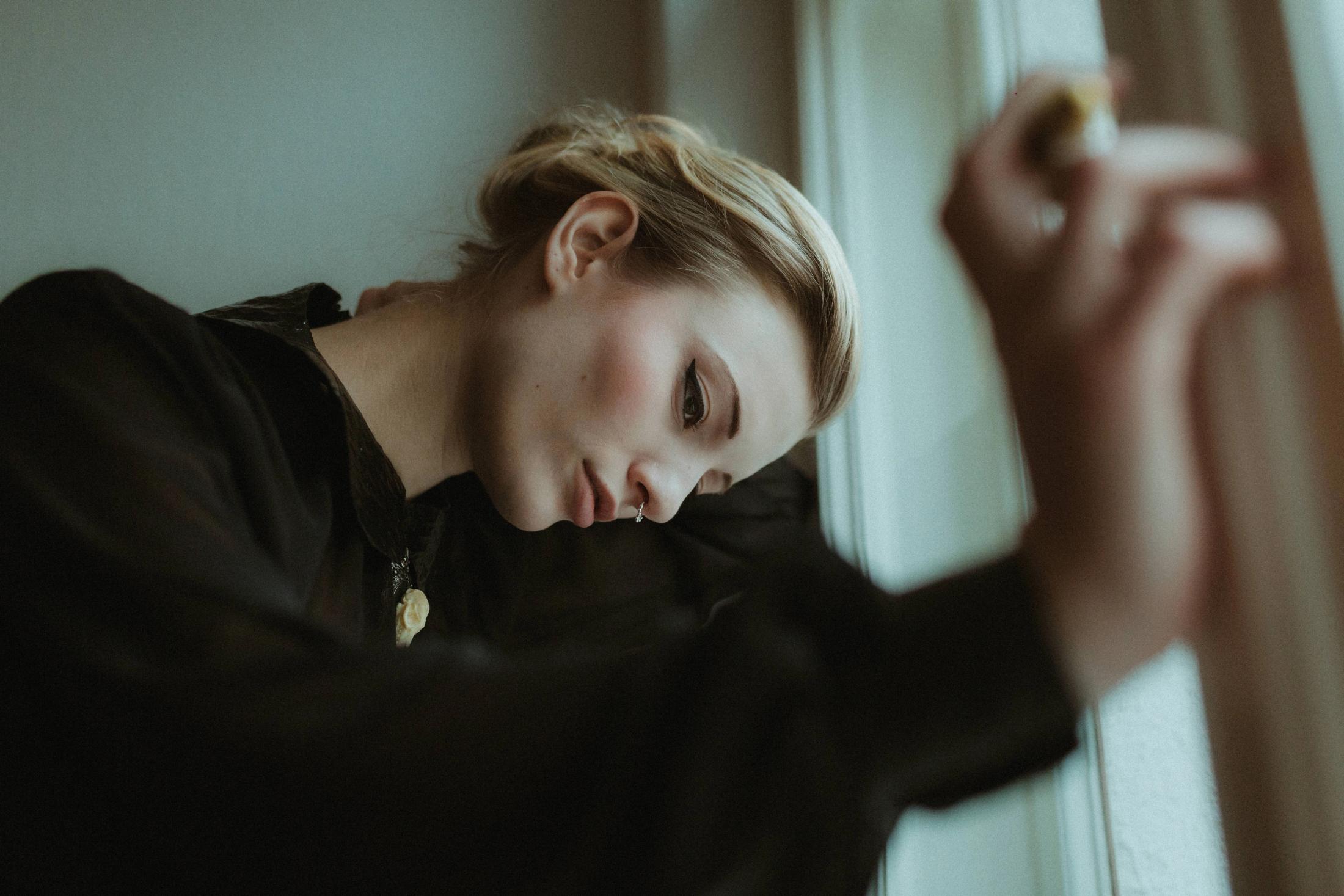 Portrait framed by a softly blurred hand