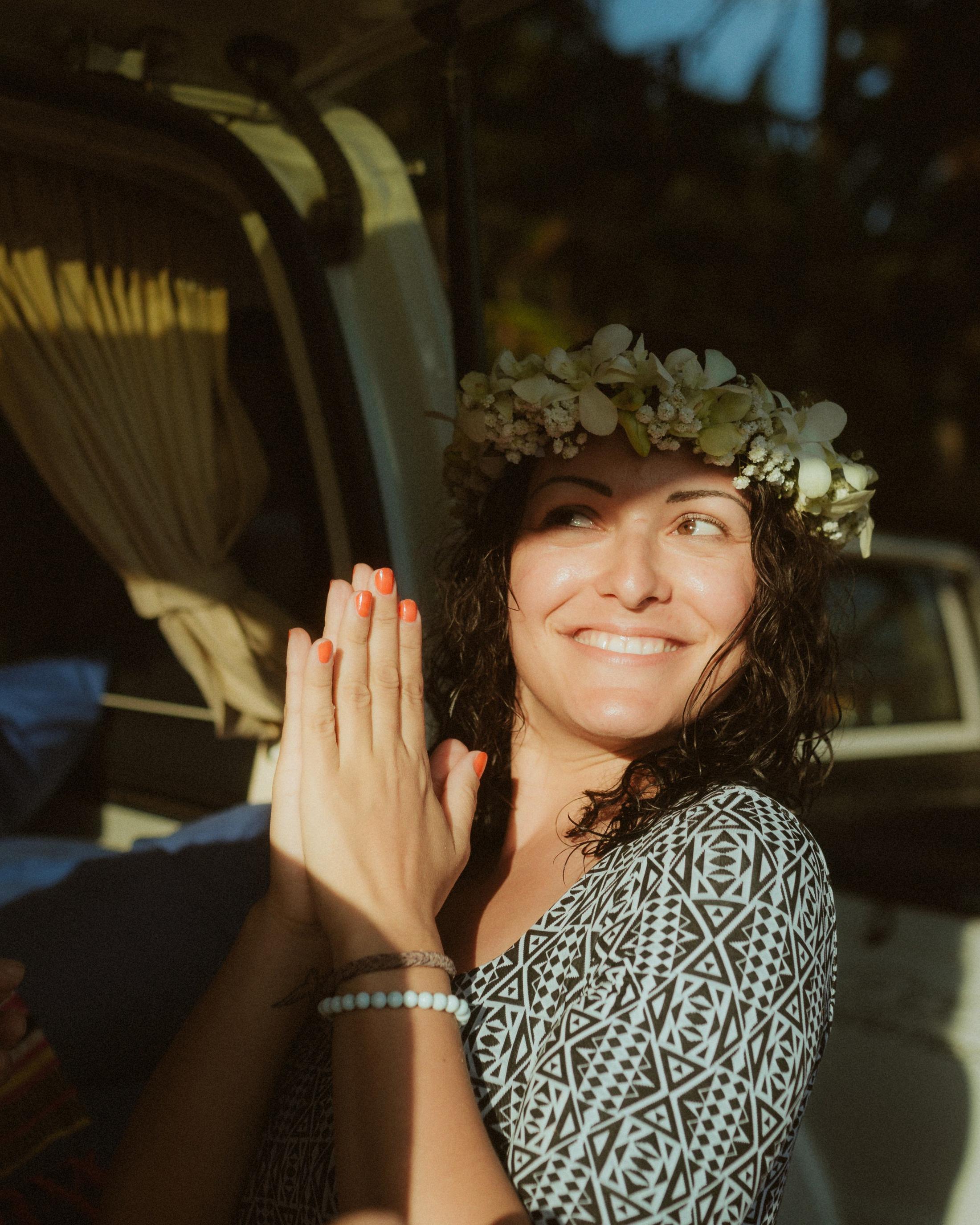 Petra smiling in the van while wearing a white flower crown