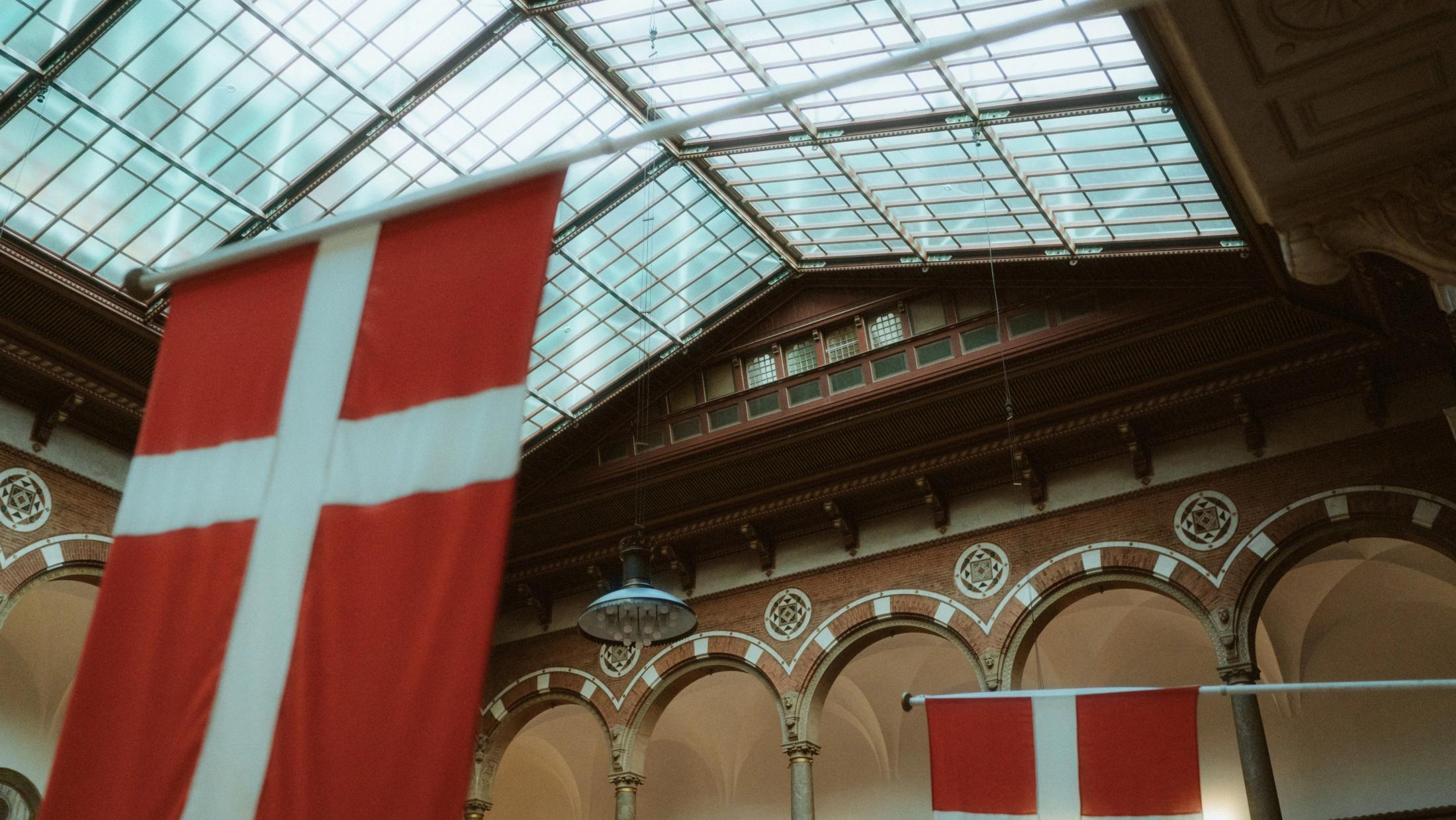 Danish flags suspended beneath the City Hall roof