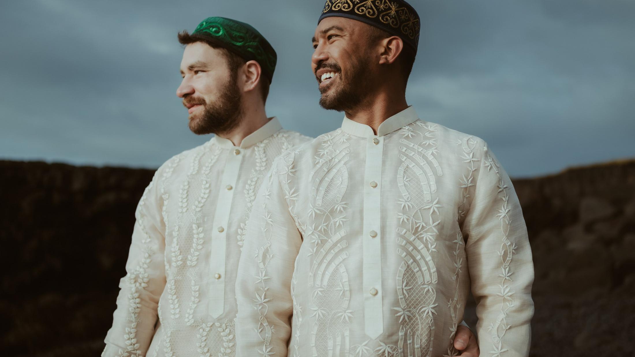 Couple standing together outdoors in patterned clothing.