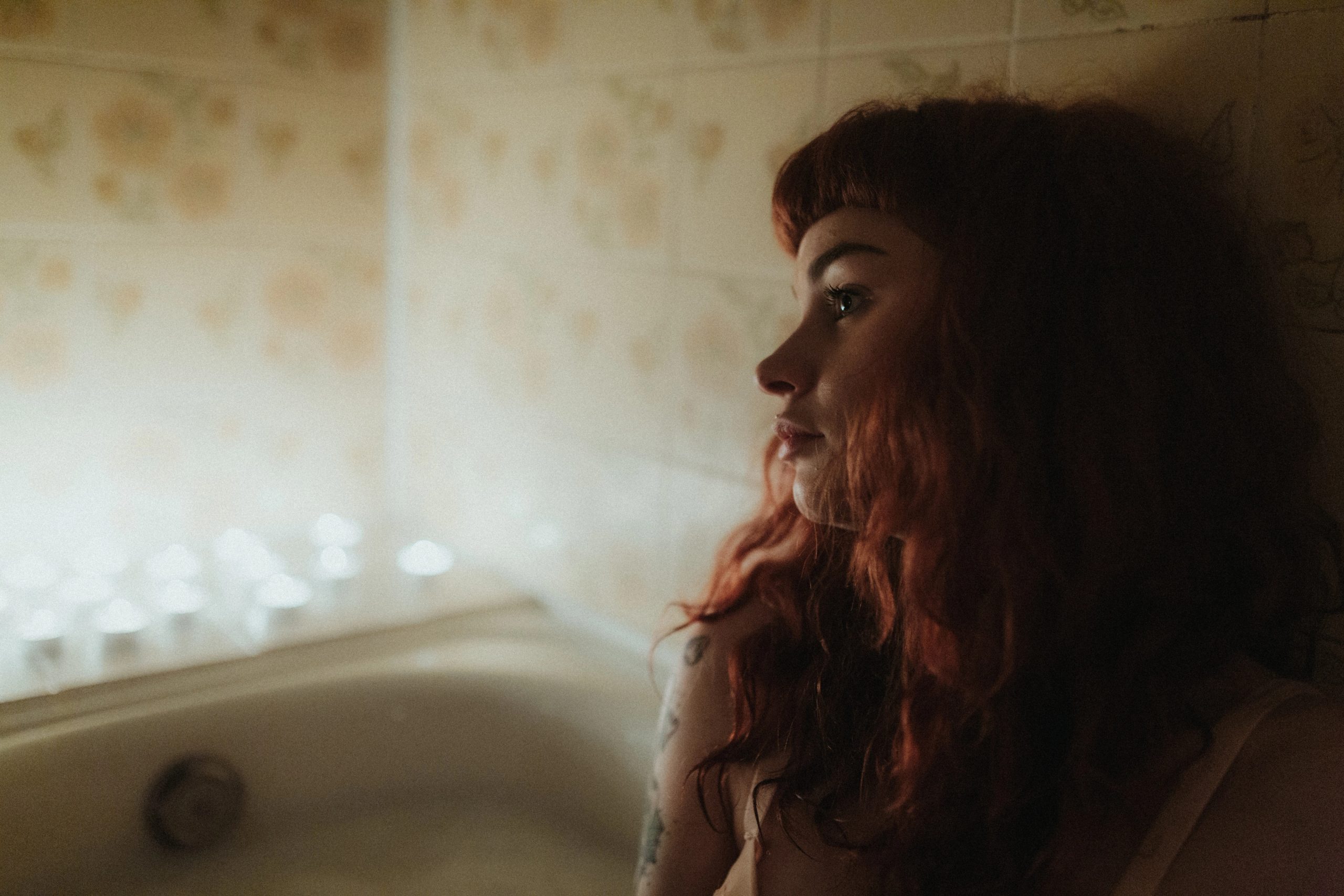 Intimate cinematic portrait of a woman in warm window light