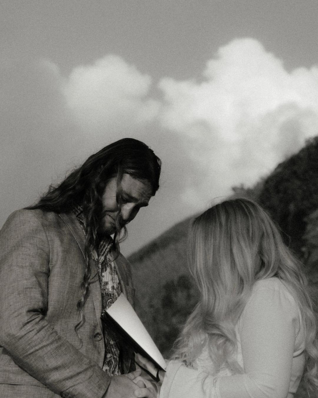 Twyla leans close to Gary during a quiet black-and-white ceremony moment.