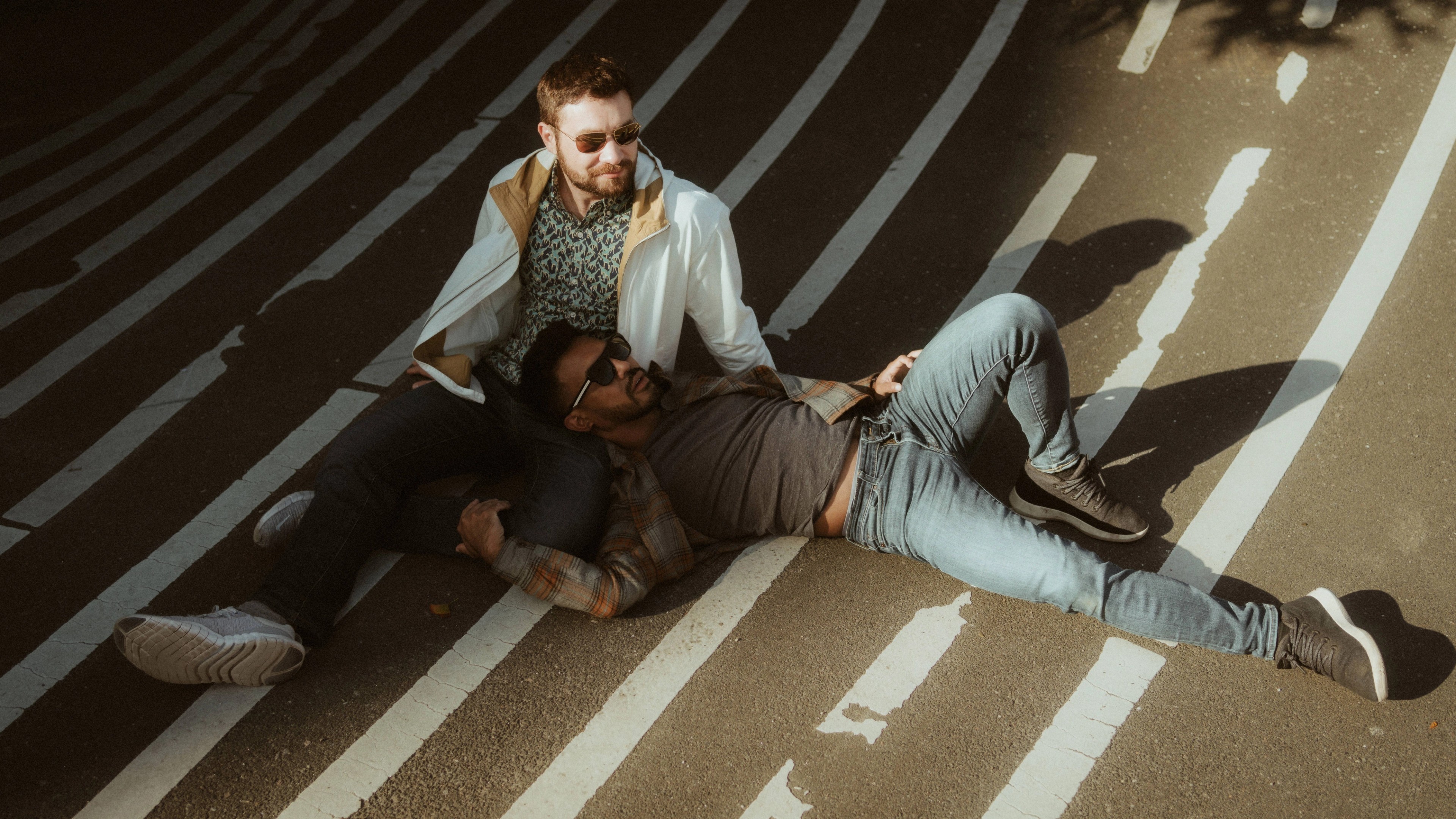 Kris and Ilya lie together across the striped ground at Superkilen.