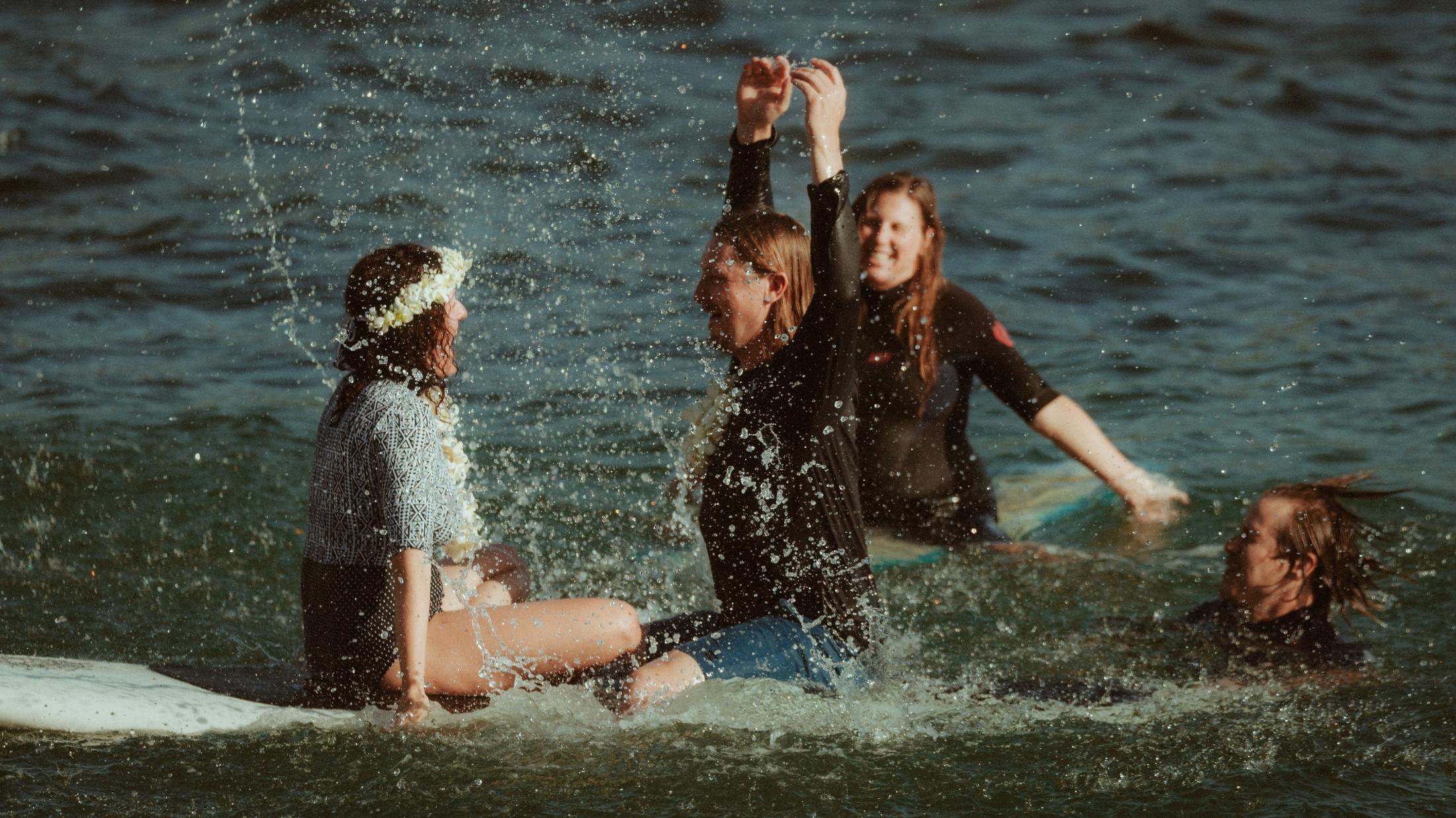 Water splashing around the boards as the ceremony group celebrates