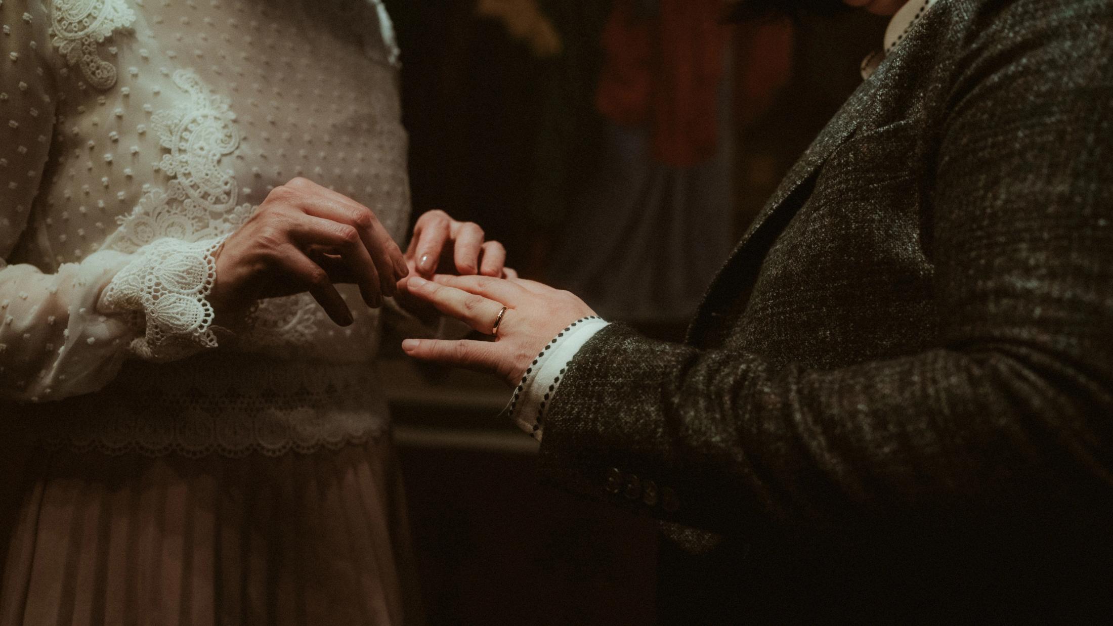 A ring being placed on a hand during the ceremony