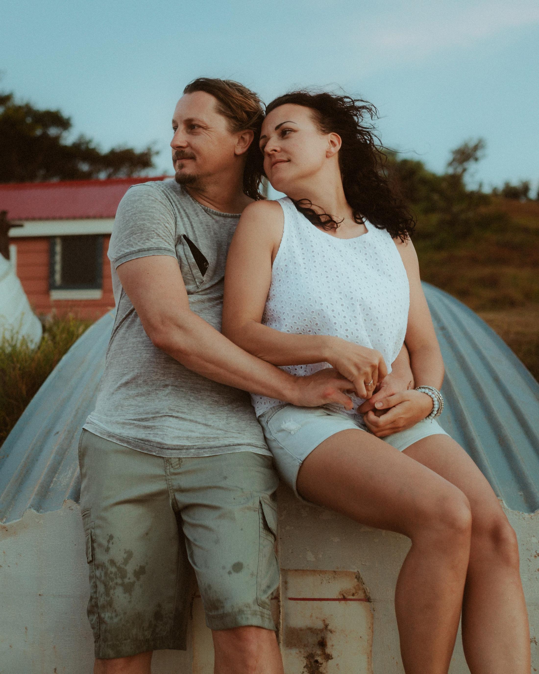 Petra and Roman holding each other in a close beach portrait