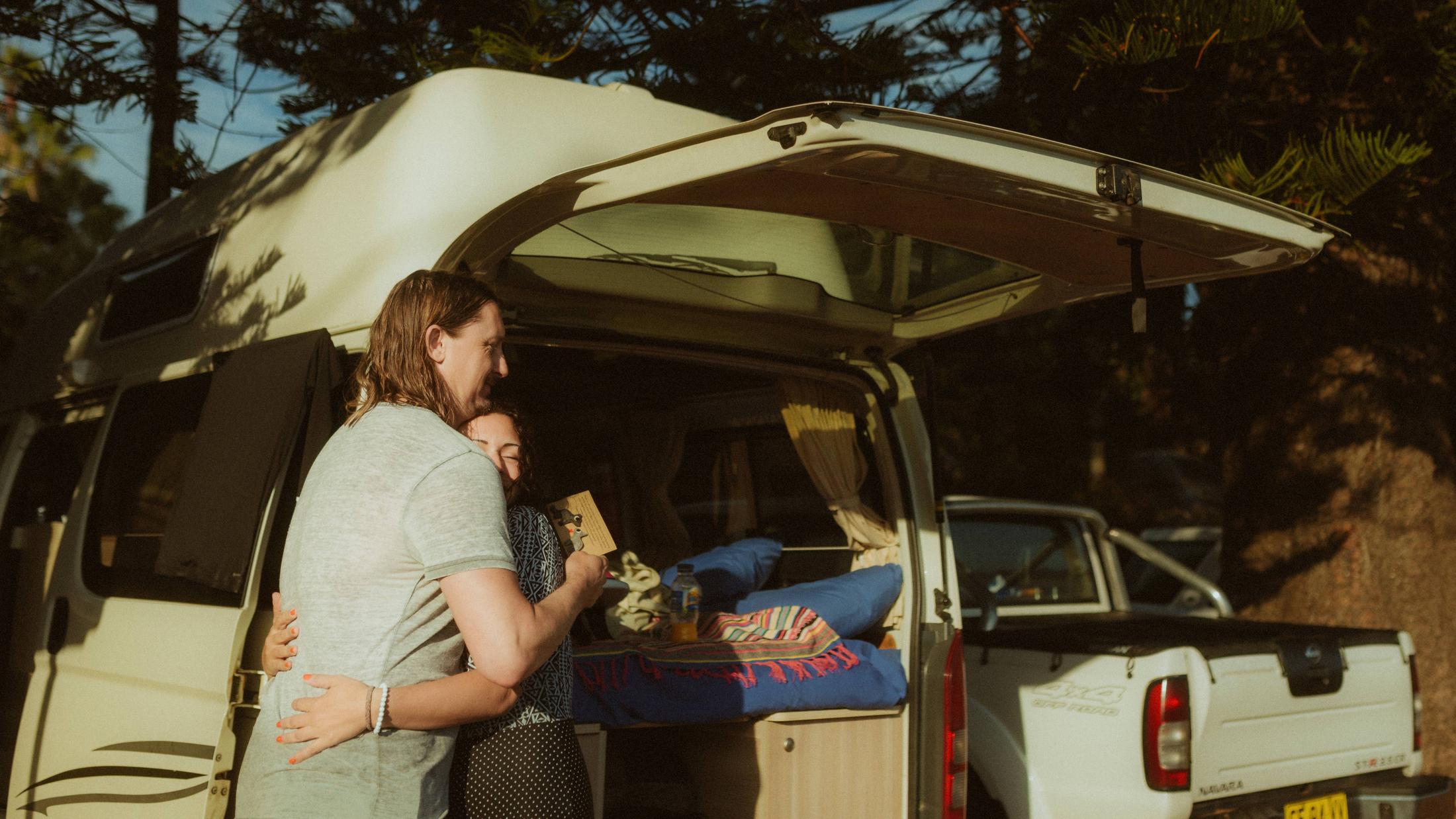 Petra and Roman embracing beside the open van after the gift