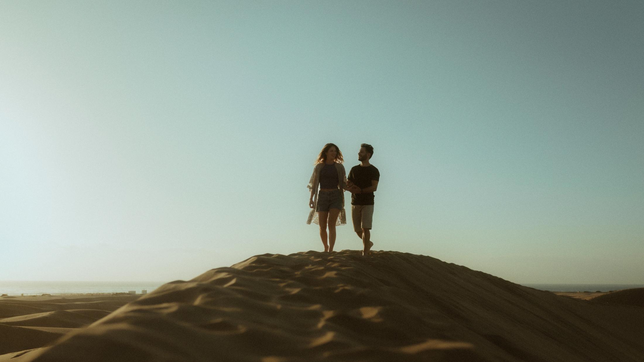 Katja and David standing as small figures on top of a dune.